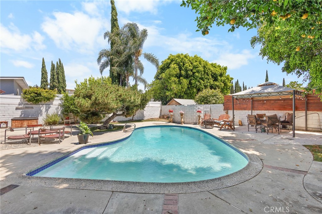 Motivated sellers! Welcome to this charming 3-bedroom, 2-bath home, privately secured with an electric gate and natural stone fencing. Features include a cozy fireplace, central air, new gas tankless water heater, upgraded 200-amp electrical panel, and energy-efficient vinyl windows and patio doors.
The backyard is ideal for entertaining, offering a sparkling heated pool, a covered patio, and plenty of privacy. Detached 2-car garage plus a 2-car driveway provide ample parking.
Additional upgrades include a new front fence with remote-controlled gate. Conveniently located near schools, shopping, dining, and major freeways.
