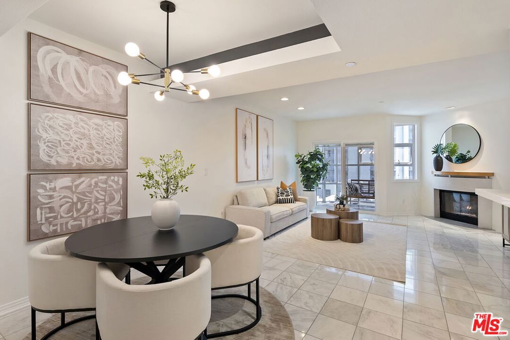 Located in a prime central Brentwood location, this private and well appointed 2-bedroom, 3-bath townhouse offers city and mountain views along with a spacious, comfortable layout spanning 1,576 square feet. A rare and valuable feature is the dual entrances, one on each level, providing added flexibility and convenience for daily living, guests, or a work-from-home setup. The upper level features an open-concept design with a modern kitchen equipped with stainless steel appliances, a dedicated dining area, and a generous living room with marble floors, a gas fireplace, and a guest powder room. A sun-drenched glass-enclosed bonus space makes the perfect office or reading nook. Downstairs, both bedrooms offer privacy and comfort. The expansive primary suite includes a sitting area, two closets (including a walk-in), and a luxurious en-suite bath with a soaking tub and separate shower. The second bedroom also enjoys its own full bath. This level also includes a side-by-side laundry area, extra storage, and direct access to a private outdoor patio. Additional amenities include Nest thermostats on each level, side-by-side parking spaces, ample guest parking, and a dedicated storage cage. The secure building offers resort-style living with a pool, spa, sauna, and gym. Ideally located near UCLA, the 405, top-rated schools, and Brentwood's premier shops and dining.