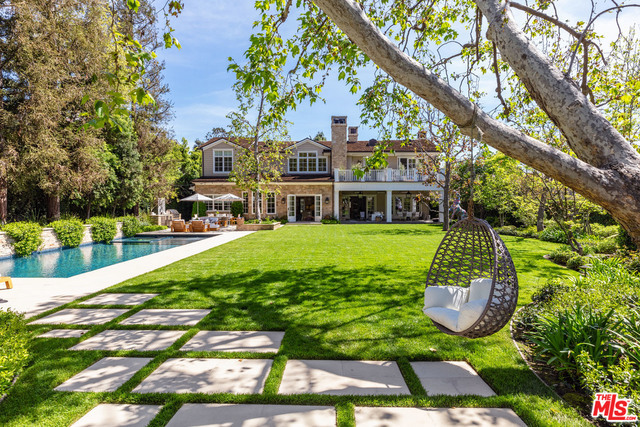Situated on one of Brentwood's largest flat lots, this transitional traditional estate was custom designed by renowned architect Philip Vertoch, a master of floorplan and natural light. Footsteps from the best dining & entertaining that Brentwood Village has to offer, including the Country Mart, Brentwood Country Club, The Getty & countless canyon hiking trails. Equipped with all the latest & greatest amenities, this stylish oversized home includes a formal living, gourmet kitchen & breakfast area that blend seamlessly into your own private backyard paradise. Elegant living & dining rooms w/ grand masonry fireplaces, paneled library, office, 2 powder rooms, massive media room & more. The exquisite master suite hosts a cozy sitting room w/ fireplace, dual walk-in closets, magnificent master bath w/ heated floors & private balcony that overlooks the estate. Surrounded by manicured gardens, entertain guests year round with outdoor fireplace & heaters, saline pool, BBQ & sport court.