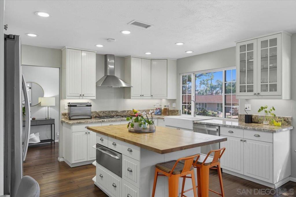 Nestled in the highly desirable Mt. Helix community, 11656 Altoona Dr is a 3-bedroom, 3 bath home on a generous half-acre lot offering privacy, space, and endless possibilities. The family room features soaring vaulted ceilings and a cozy fireplace, creating a welcoming centerpiece along with the living room for family gatherings or entertaining friends. The kitchen and bathrooms have been thoughtfully upgraded, providing both style and functionality with a large island, separate dining area and reading nook. Outdoors, the expansive yard features a fire pit and ample open space, perfect for outdoor dining, gardening, or designing your dream retreat. The two-car garage has been converted to a versatile office and storage area, while a separate laundry room adds convenience for daily living. Located in a peaceful, scenic neighborhood, this home offers easy access to top-rated schools, parks, and local shopping. Combining comfort, practicality, and the sought-after Mt. Helix lifestyle.