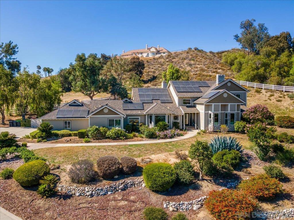 30230 De Portola Road is a stunning 3,724 sq ft custom-built estate (1983) set on 2.32 acres in the highly sought after Los Ranchitos community of Temecula. From its gated entrance and sweeping driveway to the mature landscaping and panoramic sunset views, this home blends elegance, privacy, and relaxed California living. A grand entry foyer opens to a formal living room with a fireplace and bay windows overlooking rolling hills and city lights. A warm office with custom furniture provides the perfect space for work or reflection. The large main floor master retreat offers its own private deck and a spa-inspired bath with granite topped dual vanities, oversized mirrors, and a spacious hot tub. Upstairs, three additional large bedrooms and two full baths support a flexible layout for family or guests. At the heart of the home, a chef’s kitchen features granite counters, high-end appliances, custom cabinetry, and a charming breakfast nook with French doors opening to a back patio perfect for al fresco dining or evening entertaining with your built-in grill. Above the kitchen, a grand family room with a fireplace, large windows, and double French doors extends to the rear yard and cozy fire pit. Outdoors, enjoy manicured dry scape landscaping, walking trails, mature trees, and a second build pad ideal for a vineyard, guest house, or equestrian facilities. Recent upgrades include a new furnace and AC, new water heater, and provisions for a tesla charger. The solar includes a Tesla battery for storage. Minutes from Temecula’s top-rated schools, wineries, Old Town, and Pechanga. Video tour: https://www.youtube.com/watch?v=wDpqlr867lI 3d Virtual: https://my.matterport.com/show/?m=5eqHdeMNdp9 New AC, furnace, water heater, attic insulation. House has a central vacuum system, water softener and water filtration system. Solar has a Tesla Battery for storage. The system produces more than they use. The energy bill is roughly $35 a month.