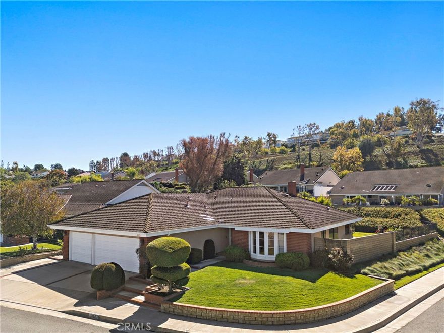 PRIME ANAHEIM HILLS AREA SINGLE-LEVEL HOME - CORNER LOT ON A QUIET CUL-DE-SAC! Discover this single-story Anaheim Hills home in the highly desirable Rocky Point subdivision, perfectly situated on a coveted 9,840 sq. ft. corner lot within a quiet cul-de-sac. This 3-bedroom, 2-bathroom residence offers approximately 2,190 sq. ft. of functional living space, providing a spacious layout ideal for families or investors seeking value and renovation potential. The home features a formal living room, formal dining room, family room with fireplace, wet bar, kitchen with breakfast nook, and a separate laundry room, complemented by multiple expansive windows in the main living areas. Enjoy seamless indoor-outdoor living with sliding doors from both the primary suite and family room to the backyard. The primary suite includes a private en-suite bathroom and generous closet space, creating a relaxing retreat. Step outside to a large front and back yard with mature landscaping, colorful planters, trees, and a covered patio, perfect for entertaining or relaxing. A 3-car garage provides ample space for vehicles, storage, or hobbies. The property offers a blank canvas with enormous potential, ready for a buyer or investor to add their personal touchand create their dream home. Located in a prime Anaheim Hills location near award-winning schools, shopping, dining, and freeway access, this home combines single-story convenience, corner-lot privacy, cul-de-sac living, and investment potential—a must-see opportunity!