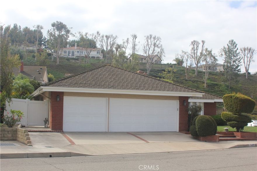 PRIME ANAHEIM HILLS SINGLE-LEVEL HOME - CORNER LOT ON A QUIET CUL-DE-SAC WITH ENDLESS POTENTIAL! Discover this single-story Anaheim Hills home in the highly desirable Rocky Point subdivision, perfectly situated on a coveted 9,840 sq. ft. corner lot within a quiet cul-de-sac. This 3-bedroom, 2-bathroom residence offers approximately 2,190 sq. ft. of functional living space, providing a spacious layout ideal for families or investors seeking value and renovation potential. The home features a formal living room, formal dining room, family room with fireplace, wet bar, kitchen with breakfast nook, and a separate laundry room, complemented by multiple expansive windows in the main living areas. Enjoy seamless indoor-outdoor living with sliding doors from both the primary suite and family room to the backyard. The primary suite includes a private en-suite bathroom and generous closet space, creating a relaxing retreat. Step outside to a large front and back yard with mature landscaping, colorful planters, trees, and a covered patio, perfect for entertaining or relaxing. A 3-car garage provides ample space for vehicles, storage, or hobbies. The property offers a blank canvas with enormous potential, ready for a buyer or investor to add their personal touchand create their dream home. Located in a prime Anaheim Hills location near award-winning schools, shopping, dining, and freeway access, this home combines single-story convenience, corner-lot privacy, cul-de-sac living, and investment potential—a must-see opportunity!