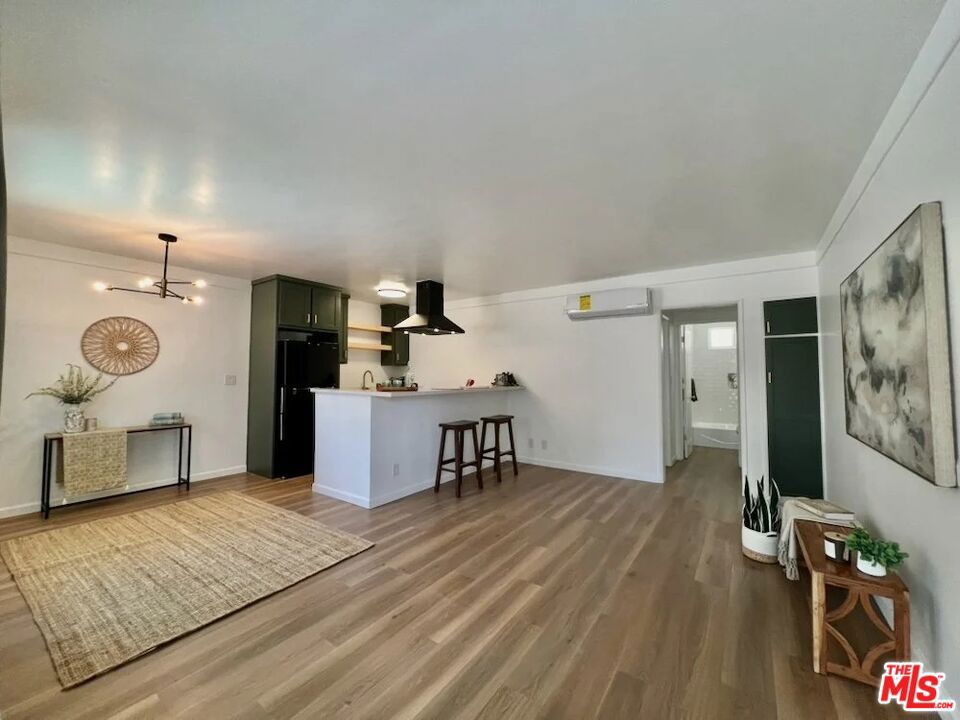 Stylish Italian-Style Mid-Century 1BR in Prime Hollywood! Beautifully renovated 900 sq ft 1BR/1BA apartment in a stunning Italian-style mid-century building in the heart of Hollywood. Prime location just two blocks from Netflix, KTLA, and Bronson Studios, minutes to Paramount & Universal. Walk to trendy restaurants, nightlife, shops, and public transit. This spacious first-floor unit features brand-new everything modern kitchen with upscale fixtures, designer finishes, and all-new flooring. One assigned parking space in the property's controlled-access lot is available for $100 per month . Building offers a communal patio and an upper balcony with breathtaking views of the city and Griffith Observatory. Experience mid-century charm with today's luxury upgrades in one of LA's most walkable, entertainment-rich neighborhoods.