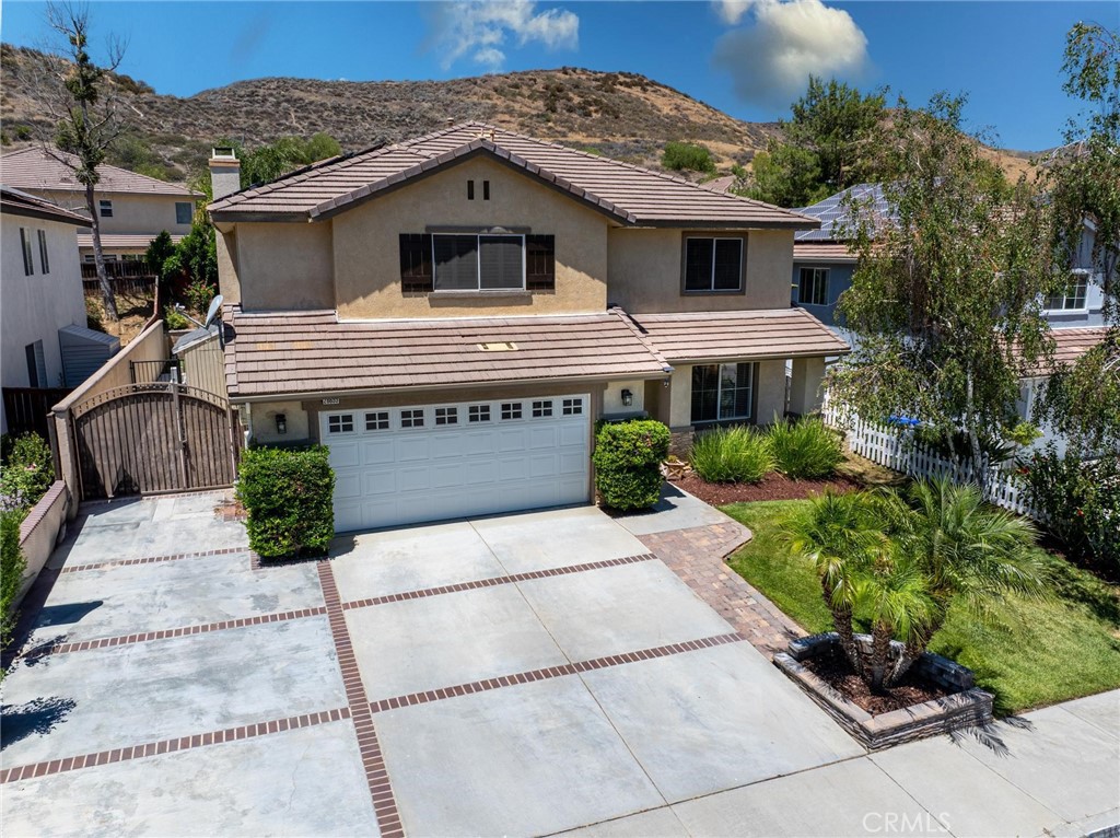 Spectacular 5-bedroom pool home at the end of the cul de sac in popular Double C Ranch Castaic! This newer community is right off the freeway, close to schools and with access to the lake and walking trails. All with no HOA or Mello Roos taxes. This is the largest model with a full bed and bath down (currently an office) and 4 bedrooms plus a loft up. All of the rooms and living space are of good size and the 27 solar panels that power it all are OWNED. There are a lot of nice upgrades including waterproof LVP plank flooring throughout the downstairs and a master bathroom remodel that will truly impress! Gorgeous tile, quartz counters and upgraded lighting. The kitchen/family room is quite spacious and the granite counters, stainless appliances, tile fireplace and custom-built ins all add to the pride of ownership you will experience. The pebble tech pool with baja shelf, covered patio, and cook station done in stack stone make for a true entertainer's yard and the wide side yard can accommodate a boat or extra toys. Great pool home!