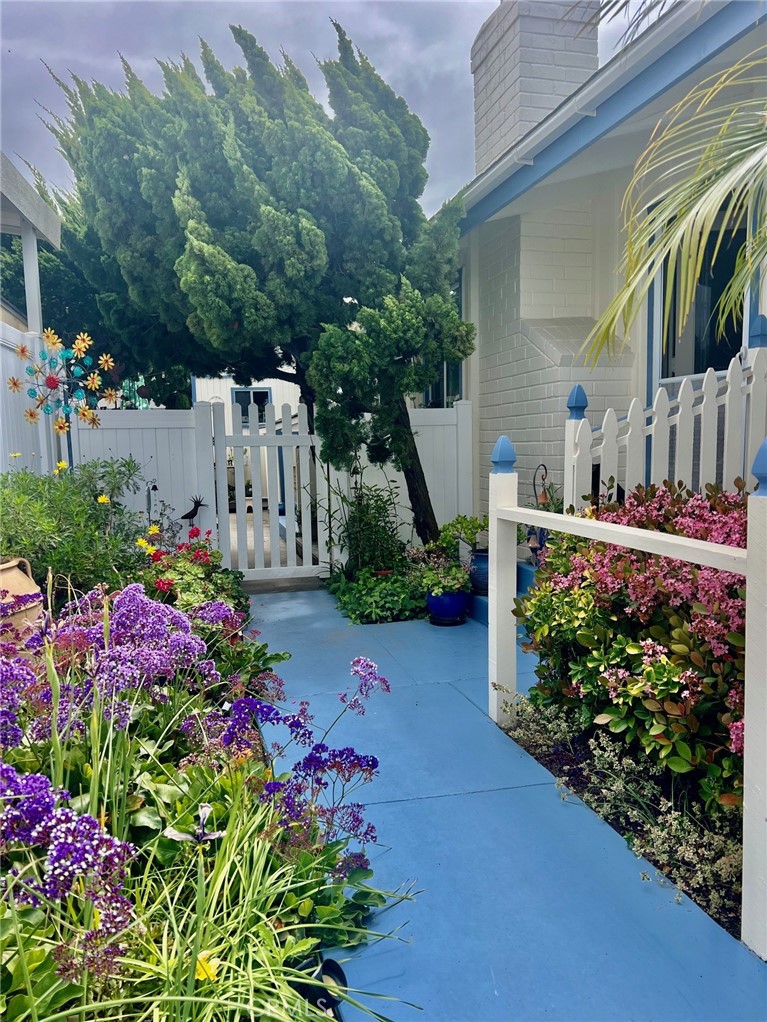Charming cottage cabana home in Bayside Village is super close to Back Bay. Open floor plan with living room, fireplace, high beamed ceilings, dining room, original kitchen and two bedrooms including a primary suite. Outside area is a large fenced patio with elegant mature trees. There is an ample carport. This property could be a great opportunity to update and open up lower ceilings to reveal the in place high beamed ceilings. Property is on leased land at $3600 monthly which includes water, trash and numerous community amenities. Bayside Village has 2 clubhouses, 2 pools/jacuzzis, private beach, sports court, outdoor barbeques and picnic areas plus a dog park! Located on Back Bay and just 1/2 mile to Balboa Island. And a short drive to world famous beaches and restaurants. Come live the Newport Beach lifestyle at a fraction of the cost of surrounding neighborhoods.