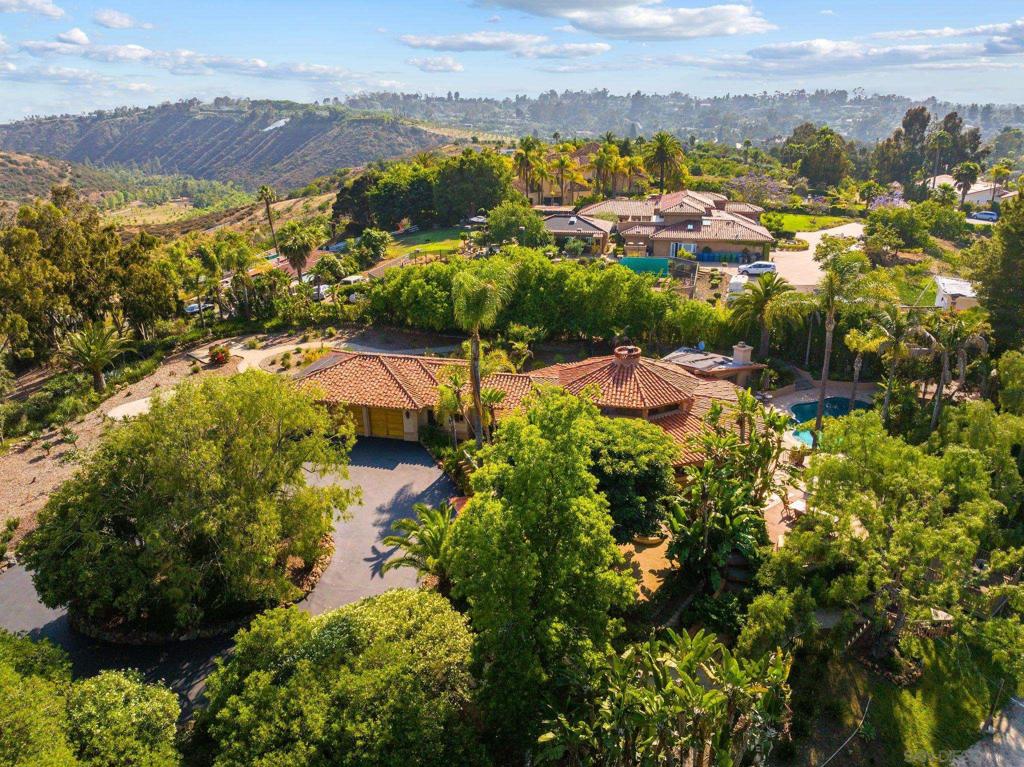 This is an exceptional Rancho Santa Fe value! The unique, well-maintained main residence features a wide open great room with high ceilings and large windows. The outdoor living areas include a vanishing edge pool with a covered cabana measuring over 500 square feet, extensive deck space, four separate seating areas, manicured mature landscaping, a sand volleyball court and even a tree house. In addition to this charming home’s 3 bedrooms and 3 baths, there is a loft office providing light-filled space not included in the square footage, and owned solar! A separate 1 bedroom, 1 bath, 741 square foot ADU with its own entrance and parking area, full kitchen, laundry, living room and a view deck almost as large as the structure was added in 2020. Both homes are sited on 2.98 view acres with plenty of room to add space and enjoy spectacular westerly views and to keep a few horses. Quiet and private, this property is ready to move right in and enjoy, with unlimited potential. The home includes an oversized 3 car garage and an extra-large laundry room. Voluntary HOA of $250/year.