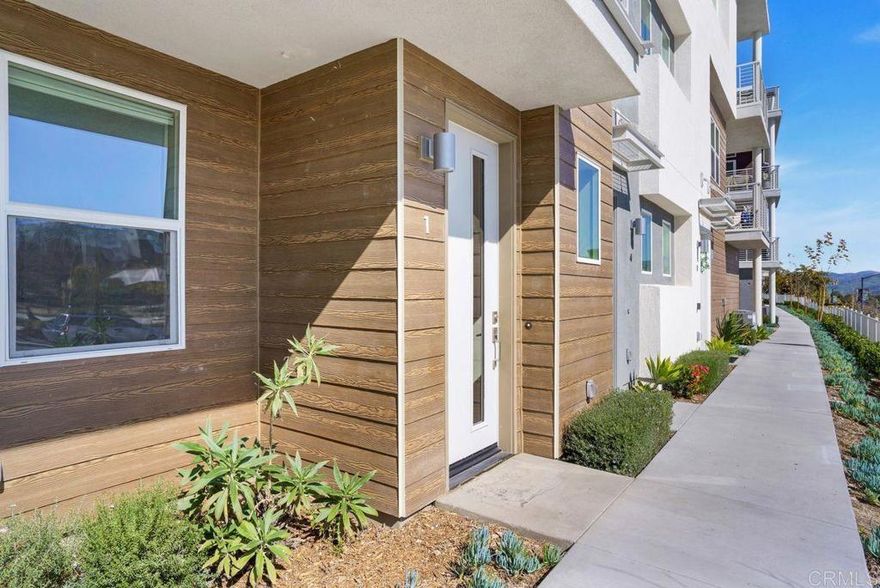 Discover Modern Living in the Heart of Millenia!  This stunning, like-new, 2-story townhome offers 3 spacious bedrooms and 3 full baths, providing both comfort and convenience. Enjoy the flexibility of having a bedroom and full bath on the 1st floor, perfect for guests or those seeking easy access. The master suite features a walk-in closet, and an additional bedroom is also located on the main floor for added privacy. The home boasts upgraded flooring throughout and a stunning open layout that highlights the modern design and craftsmanship.  Relax on the balcony in the living room, where you can take in breathtaking views of the community park and mountains. This home is within walking distance to shops, schools, Otay Ranch Mall, and more, offering the perfect balance of tranquility and accessibility.  Enjoy access to the resort-style pool and all amenities offered by the HOA, including parks, dog parks, and a brand-new community pool.