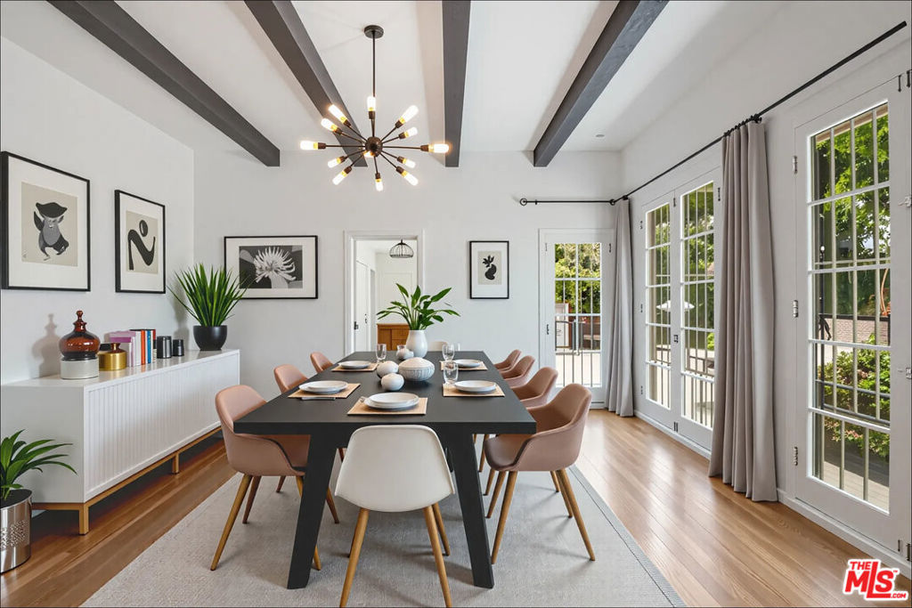 Charming 1920s townhouse-style duplex with hardwood floors, floor-to-ceiling windows providing lots of natural light, in-unit washer/dryer, & rear garage (large 1 car garage + 1 driveway spot). Downstairs offers a spacious living room, large dining room w wood beam ceilings, & oversized kitchen with full appliance package (microwave, new double oven, fridge, dishwasher, gas range) large breakfast area & a half bath. Upstairs features 3 bedrooms + 2 bathrooms. The front bedroom offers 2 large walk-in closets (one could be an office), a second BD with ample closet space & bathroom in-between the 2. The primary bedroom boasts double closets, vanity space, built-ins for storage, & an en-suite BA providing dual vanity, tub/shower, + large linen closet. Grassy courtyard, timeless character & unbeatable Beverly Grove location complete this rare offering.