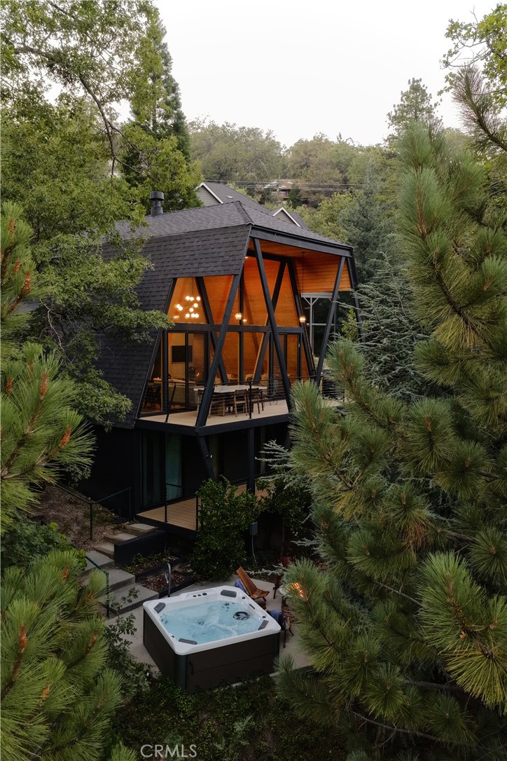 Welcome to The Great Escape!
Tucked in the trees, sitting above the lake, and wrapped in glass, this fully renovated home blends modern design with warm, natural textures. Cathedral ceilings, lake views, and unique architecture make it feel like a true mountain retreat.
Taken down to the studs and rebuilt with intention, every detail was done right. New HVAC, plumbing, electrical, and high-end finishes that feel organic to the space. The home comes fully furnished with curated pieces from Crate & Barrel for added ease and style.
A wall of glass floods the main living area with natural light and frames the views of the trees and lake. A bold fireplace grounds the space, while the large deck extends your living area outdoors. The kitchen, dining, and living all flow together effortlessly, an easy, comfortable space to hang out and feel at home.
Upstairs is your own private lofted primary suite. Downstairs, you’ll find three additional bedrooms and access to an expansive lower deck and private spa area, complete with a firepit to keep things cozy.
And just when you thought this one couldn’t get any better, just across the street is the lake trail, and your own dock (one of three on a shared triple-slip) is included, making this the ultimate lake house package.
With near level entry, a two car garage, and a location just minutes from the lake, village, and Blue Jay… The Great Escape checks all the boxes. Whether you're looking for a successful short-term rental, a weekend getaway, or place to call home full time, this one has it all.