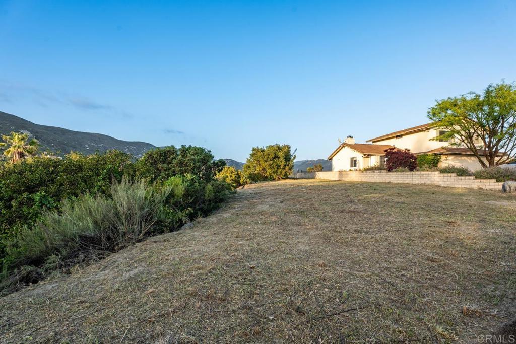 Welcome to an exceptional opportunity in the heart of San Diego Country Estates — a 0.64+/- acre residential lot offering panoramic views and a rare head start on your dream build. This beautiful parcel comes with architectural plans already approved, school fees paid, and utilities in place, including a water meter, sewer connection, and available electricity. Whether you're ready to build now or planning for the near future, this property is positioned for a seamless start. Set on a gentle rise with expansive views of the surrounding hills and valleys, the lot provides an inspiring canvas for a custom home that embraces both the land and the lifestyle. Ideal for builders and investors seeking a turnkey project, or for buyers ready to create a personal sanctuary in a community that blends nature, recreation, and neighborly charm. San Diego Country Estates is a beloved enclave known for its open space, miles of trails, golf course, equestrian amenities, parks, tennis courts, and a community center with a pool and fitness room. Just a short drive from downtown Ramona’s shops and dining, and within reach of local wineries and outdoor adventures, this offering pairs convenience with the peaceful pace of country living. Come explore the possibilities and build your vision where the sky feels just a little bigger.