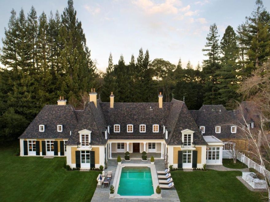 This estate (known as "Hilltop House") is a masterful combination of timeless French architecture, by Gardner Dailey circa 1935, and luxurious updates for 21st century living. Spanning ~3.4 acres, the setting is quintessential Woodside, set far back from the street with added layers of privacy from redwood groves and a vast meadow adjoining a conservation easement with unobstructed views. The 3-story residence is classically appointed with hardwood floors, refined millwork, and grand formal rooms complemented by a parlor, entertainment bar, library and chef's kitchen. Personal quarters are many with a total of 8 bedrooms, including the lavish multi-room master suite, plus extended family living quarters with full kitchen, and lower-level staff quarters. The impressive grounds include a pool, tennis court, and sun-swept lawns ready to host family or philanthropic events. Located in the heart of central Woodside just minutes to Stanford, Silicon Valley and 2 airports. Woodside Elementary