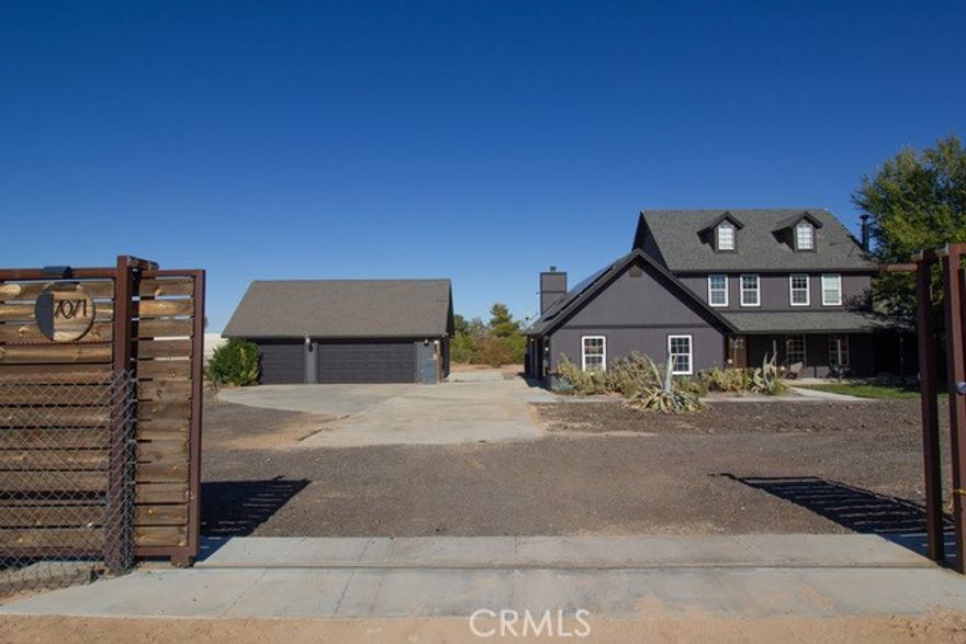 Welcome to this stunning, fully remodeled modern farmhouse that perfectly blends rustic charm with contemporary luxury. Set on just over 2 acres of  land, this home offers both elegance and functionality. Step inside to an open-concept floor plan featuring designer finishes, high ceilings, and top-of-the-line appliances throughout. The gourmet kitchen boasts custom cabinetry, a large center island, and premium stainless-steel appliances including a 48 inch professional hood and range—ideal for both entertaining and everyday living. The spacious primary suite offers a serene retreat with spa-like amenities, while additional bedrooms provide comfort and flexibility for family or guests-all located on the second floor. Outside, enjoy the best of country living with a stock tank pool, outdoor fire pit, and ample yard space for recreation or relaxation. The property includes an attached 2-car garage plus a separate 3-car garage, providing abundant storage and workspace. Fitness enthusiasts will love the custom C-container gym, while equestrians can take advantage of the private horse arena that comes complete with a 40 foot container used to store tack and feed. Powered by solar energy and equipped with two Tesla Powerwalls-saving over $6,000 for the year, this home delivers sustainability without sacrificing style. Every detail has been thoughtfully designed, making this chic farmhouse estate the ultimate blend of sophistication, comfort, and modern country living.