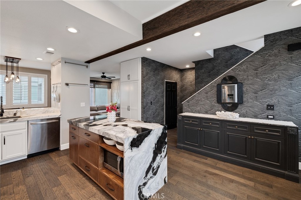 Welcome to your dream beach retreat at 501 Herondo St #50—an extensively renovated townhome just blocks from the sand, featuring its own private front door entry on the quiet cul-de-sac of Hill Street! Nestled within the desirable Moorings community, this 3-bedroom plus bonus room, 3-bathroom residence offers a perfect blend of modern upgrades, abundant storage, and natural light for a laid-back coastal lifestyle—plus access to the community’s sparkling pool and relaxing jacuzzi.
The bright and airy living room features soaring ceilings, hardwood floors, a cozy fireplace, and sliding doors that open to a sunny patio—ideal for morning coffee or evening unwinding. The updated kitchen is a chef’s delight with marble countertops, an island with counter seating, stainless steel appliances, custom cabinetry, and a built-in pantry. Upstairs, the spacious primary suite boasts a walk-in closet, custom built-ins and a beautifully updated en-suite bath. Two additional bedrooms and a full bathroom provide flexibility for guests, a home office, or a growing family.
A standout feature is the versatile downstairs bonus room—perfect for a home gym, office, playroom, or extra storage—located off the 2-car garage with laundry, this flexible layout makes daily living effortless.
Just a few blocks from The Strand, the beach, and the greenbelt path, this home is truly a beach lover’s paradise. Enjoy easy access to Pier Avenue’s vibrant shops, dining, and local favorites, and come home to the Moorings community’s resort-like amenities.