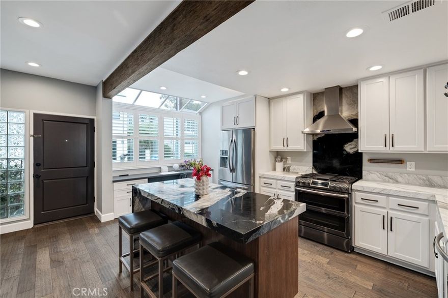 Welcome to your dream beach retreat at 501 Herondo St #50—an extensively renovated townhome just blocks from the sand, featuring its own private front door entry on the quiet cul-de-sac of Hill Street! Nestled within the desirable Moorings community, this 3-bedroom plus bonus room, 3-bathroom residence offers a perfect blend of modern upgrades, abundant storage, and natural light for a laid-back coastal lifestyle—plus access to the community’s sparkling pool and relaxing jacuzzi.

The bright and airy living room features soaring ceilings, hardwood floors, a cozy fireplace, and sliding doors that open to a sunny patio—ideal for morning coffee or evening unwinding. The updated kitchen is a chef’s delight with marble countertops, an island with counter seating, stainless steel appliances, custom cabinetry, and a built-in pantry. Upstairs, the spacious primary suite boasts a walk-in closet, custom built-ins and a beautifully updated en-suite bath. Two additional bedrooms and a full bathroom provide flexibility for guests, a home office, or a growing family.

A standout feature is the versatile downstairs bonus room—perfect for a home gym, office, playroom, or extra storage—located off the 2-car garage with laundry, this flexible layout makes daily living effortless.

Just a few blocks from The Strand, the beach, and the greenbelt path, this home is truly a beach lover’s paradise. Enjoy easy access to Pier Avenue’s vibrant shops, dining, and local favorites, and come home to the Moorings community’s resort-like amenities.