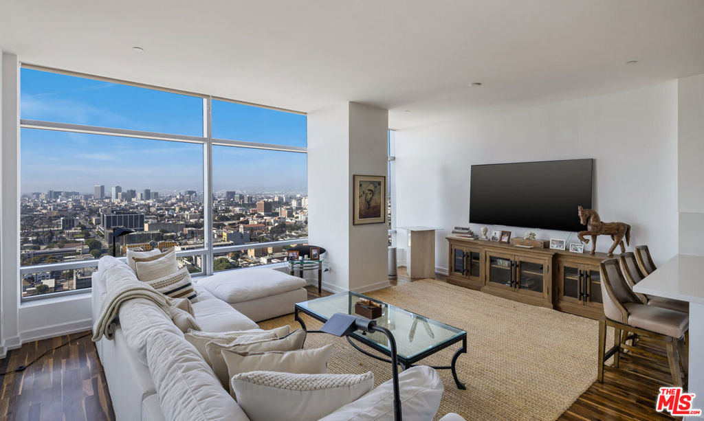 Indulge in unmatched luxury with this stunning 29th-floor condo at The Ritz-Carlton Residences, one of downtown's most iconic landmarks. This expansive 2-bedroom, 3-bathroom home features panoramic views stretching from Downtown to the Hollywood Hills and the Ocean. The open-concept kitchen is a culinary masterpiece, featuring top-tier cabinetry and appliances. The primary suite offers a spacious walk-in closet and a spa-inspired bathroom, complete with a soaking tub and a unique peek-a-boo window. With two valet parking spaces, this residence elevates urban living with world-class amenities, including a billiard room, pool and spa, screening room, concierge services, and a cutting-edge gym. Experience the vibrant downtown LA lifestyle in this extraordinary home.