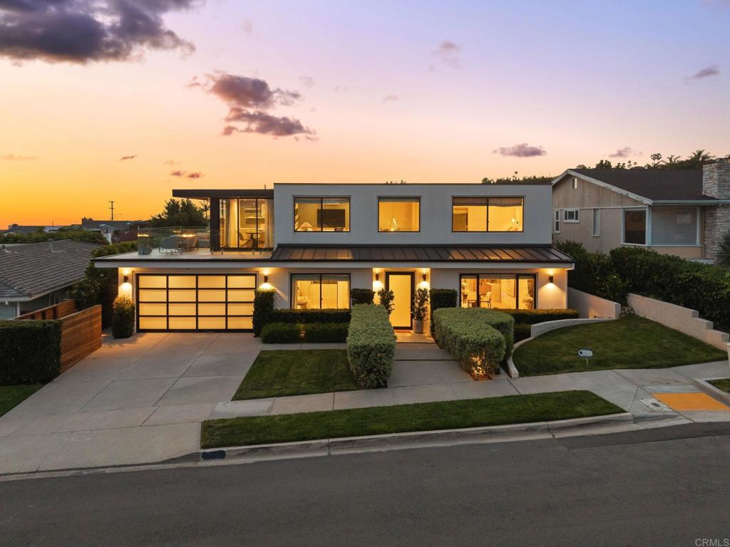 Nestled in the scenic hills of La Jolla, 5530 Candlelight Drive is a 3,364 sq ft retreat that blends modern elegance with laid-back coastal charm. With 4 bedrooms, 4.5 bathrooms, and a flexible layout, it’s perfect for both relaxed living and stylish entertaining. The open-concept great room flows into a chef’s kitchen featuring a Bosch dishwasher, two built-in Wolf ovens, sleek cabinetry, and a spacious island. Natural light pours in through large windows, highlighting the seamless indoor-outdoor design. Two en-suite bedrooms are located on the main level, while a private-entry attached casita with its own kitchenette offers ideal space for guests or a home office. Upstairs, a cozy family room with wet bar opens to a stunning view deck through sliding pocket doors—framing panoramic views of the ocean, Mission Bay, and city lights. The luxurious primary suite includes a spa-like bath and mirrored doors that reveal breathtaking vistas. Outside, enjoy two covered patios, a jacuzzi, sauna, and spacious yard—an entertainer’s dream. From world-class beaches and top-rated schools to fine dining and boutique shopping, La Jolla offers the best of Southern California living. Schedule your private showing today and discover the beauty and lifestyle that await at 5530 Candlelight Drive.