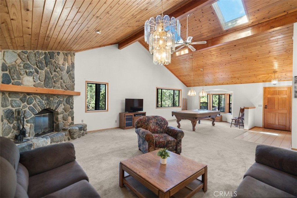 Welcome to your mountain retreat at 2109 Symonds Dr—where stunning views and serene living are a daily reality. Nestled on a generous 0.26-acre lot, this spacious 3-bedroom, 2-bathroom home spans 2,320 sq ft and is thoughtfully designed for both grand gatherings and quiet, reflective moments. Step inside and be greeted by soaring vaulted ceilings that amplify the natural light and frame the breathtaking scenery of Pine Mountain Club through every window. Whether you're cozying up by the fireplace on a crisp evening or hosting a lively dinner party with friends, the open-concept layout seamlessly blends comfort with elegance. A laundry chute adds convenience, while every room is oriented to make you feel more connected to nature. Recent updates elevate this mountain haven even further, including a brand new front door and a new main water pipe from the meter to the house, offering both style and peace of mind. The location is unbeatable—perfectly placed on Symonds Drive, just a short and scenic stroll to Lampkin Park and the charming village center. You'll enjoy easy access to Pine Mountain Club’s exceptional amenities: a refreshing pool, a challenging golf course, equestrian center, tennis courts, and a vast network of hiking and biking trails. For those seeking even more adventure, nearby campsites and forest escapes await. A spacious two-car garage provides room for all your gear and seasonal toys. Whether you're looking for a full-time family residence, a weekend getaway, or a property with excellent Airbnb potential, 2109 Symonds Dr is a turnkey opportunity to live the mountain lifestyle you’ve been dreaming of. Come see it, schedule your showing today!