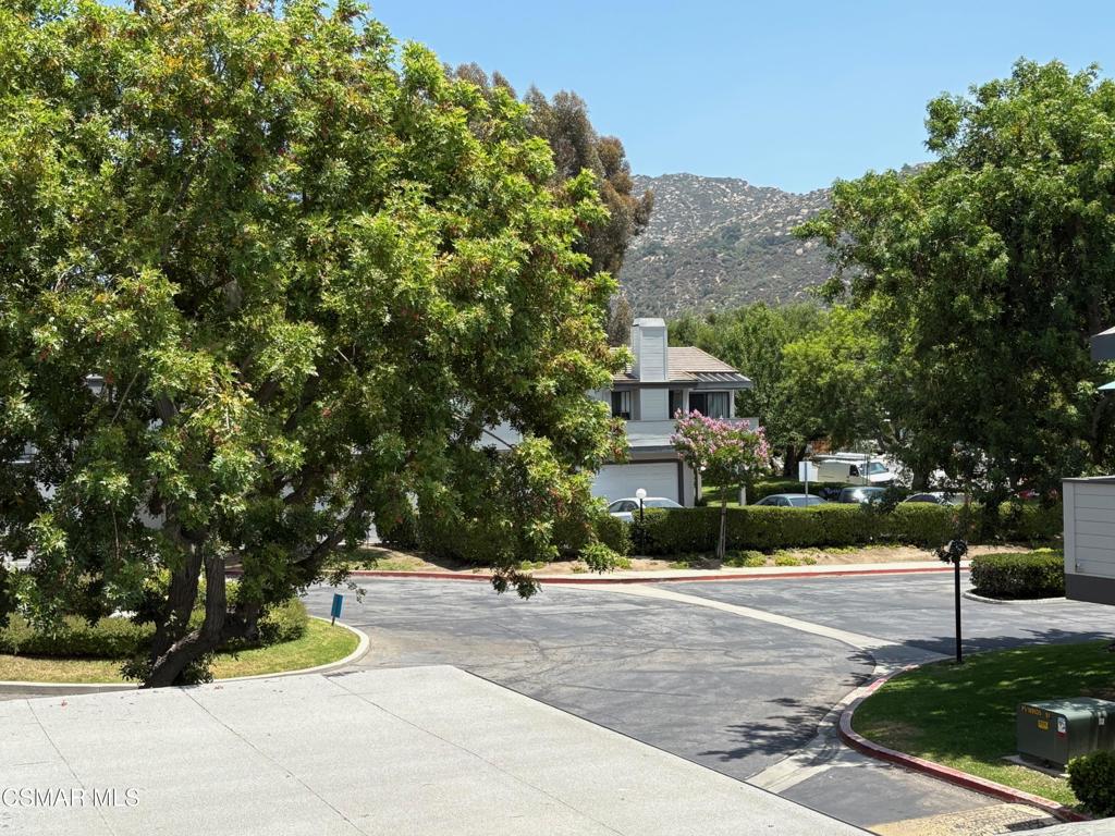 Enter into the serene setting of this penthouse condo with views of the mature, manicured grounds and Simi Hills. Newer dual-pane slider, 'portal' window/'skylights', dishwasher and unique, black 'granite' sink in kitchen with garden window that frames the patio and view! 2 bedrooms and 2 FULL baths, fireplace, vaulted ceiling, TWO-car, PRIVATE garage, some fresh paint and full-size, IN-UNIT laundry area that's conveniently UPSTAIRS. Rare Community TENNIS court and TWO refreshing pools and spas. Ideally located near historically-renowned Corriganville movie (and Hopetown motocross) Park, first-class Santa Susana Railroad Depot/Museum, popular Knolls Park and scenic hiking/mountain-biking trails that go on and on for miles of beauty! Enjoy East Simi's quintessential sandstone mountains, rare outcroppings and huge boulders. Plus, 'Chumash-fashioned' caves and bowls, sprawling ancient oaks and cliff-dropping seasonal streams, all in close proximity to your own front door (and commute to L.A.?). And this, highlighted by our rich indigenous, rancho, farming, oil, aerospace and first-responder heritage, with the bonus of Mediterranean-like weather!