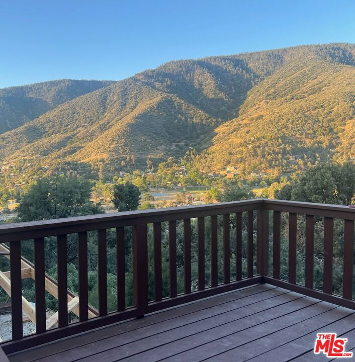 **** PROPERTY HAS GONE THROUGH AN EXTENSIVE MAKE OVER. NEW PHOTOS TO FOLLOW****Welcome to your dream mountain retreat. This lovingly updated 4-bedroom, 2-bath cabin offers over 2,000 square feet of comfort, charm, and modern convenience, all surrounded by breathtaking mountain views. Perched in a peaceful, private setting, the home is bathed in natural light, with large windows that showcase the stunning landscape from nearly every room.Step inside to an inviting open-concept living area featuring a cozy fireplace, perfect for chilly mountain evenings. The interior has been freshly painted, giving the space a clean, modern feel while still honoring the warm, rustic character of the cabin. Multiple newly built decks wrap around the home, offering incredible outdoor living spaces where you can relax, entertain, or take in the stars.The thoughtfully designed layout includes three bedrooms on the main floor and a separate lower-level suite with its own entrance ideal for hosting guests or generating rental income. This versatile space can serve as a private getaway or a fully functional rental unit.Additional upgrades include a brand-new pad for a larger propane tank, ensuring efficiency and ease, and high-speed internet via Starlink, so you can stay connected while enjoying off-the-grid tranquility. Every detail of this cabin has been cared for and improved with intention, making it truly move-in ready.Whether you're searching for a full-time residence, a vacation home, or an investment with income potential, this mountain cabin has it all natural beauty, modern amenities, and that rare sense of peaceful escape. Truly a SHOW STOPPER!