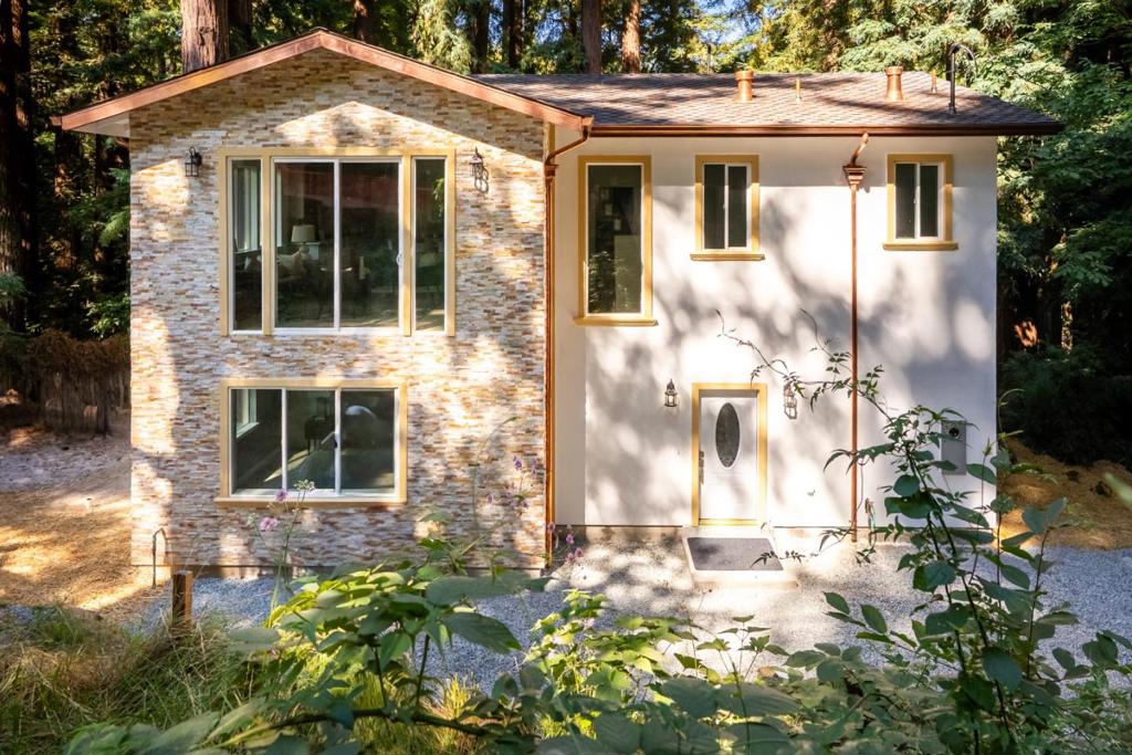 Charming brand-new custom home in tranquil Boulder Creek. Beautiful Carmel Stone facade framed in the tall redwoods invokes a touch of Carmel and Boulder Creek styling. With 2,066 square feet of living space, this 3 bedroom, 2.5 bath home is designed for both entertaining and intimate escapes. Custom amenities include a large open-concept gourmet kitchen, spacious living room with vaulted ceilings, bonus room, and an outdoor deck (under construction) that is ideal for sunset entertaining or quiet stargazing among the redwoods. Distinctive details include extra-large tile flooring throughout, floor-to-ceiling tile in the dual-sink bathrooms and laundry room, Italian marble-style countertops, custom kitchen cabinets, copper cladding on exterior facia with copper rain gutters, downspouts, and roof fixtures. Recessed lighting, custom Brazilian Sapele wood stairway railings, and motion sensor lighting in bathrooms and laundry room. Located in the acclaimed San Lorenzo Valley School District with schools just minutes away.