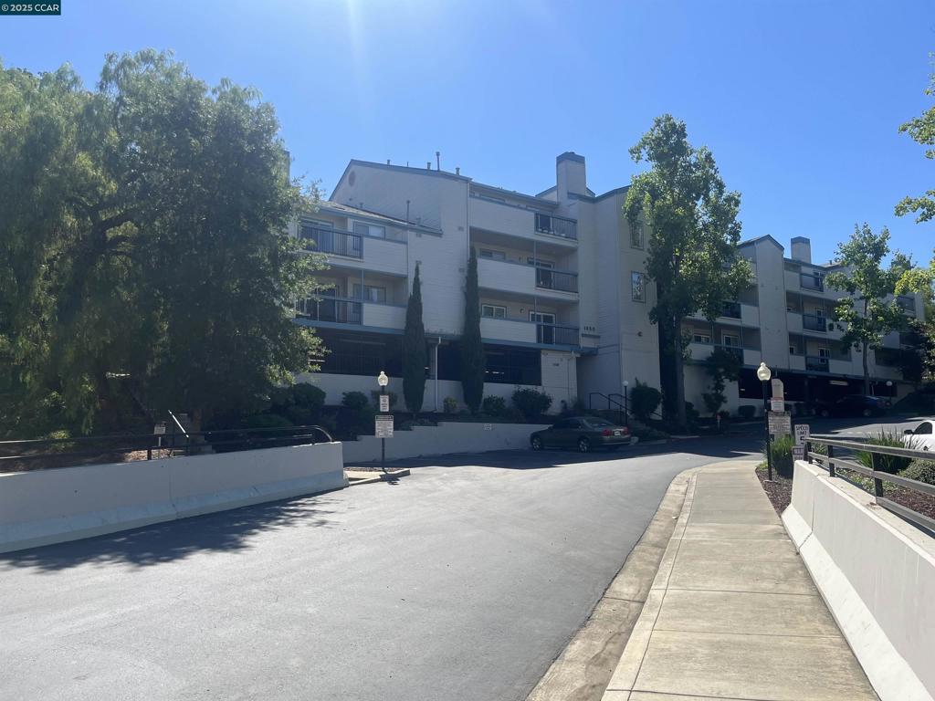 Do not miss this opportunity, situated in a great location in the complex. This 2 bedroom, 2 full bathrooms is the largest model with 1,122 sq. ft. Stunning and beautifully updated, starting with the kitchen's lovely Granite Counters, Stainless Steel appliances, next to your stack washer and dryer, ending with an oversized pantry. A Spacious Primary Bedroom, huge walk-in closet and a Large Primary Bathroom with a granite walk-in shower, dual wash basins and granite countertop. The Large Living Room with a tiled fireplace and access to the patio by way of a sliding glass door. Laminate flooring throughout the unit. Both bedrooms are separated by the Living room for each one's privacy. This unit is in a quiet location, with only two neighbors, and an extra window in the Primary Bedroom. Note that there are shutters throughout this unit. The best for last, this unit includes TWO dedicated parking spaces under the building with secure gate access. Building has an elevator access inside the building for safety. Community pool, Club house, Close to Newhall Park and shopping. Make this your home today!