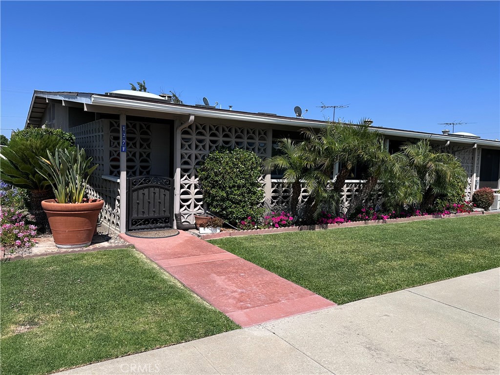 Make this Your next Home! This 2 Bedroom, 1 and a half Bath Corner unit has the best of both inside and outdoor living that is what So Cal Beach City Living is known for!! Enter through a double door (with invisible screens) and you will find newer remodeled everything with upgraded accents and details. The open kitchen is light and bright from a large flared skylight with an electric opener, plus beautiful quartz countertops and ocean blue accent tile backsplash, plus a peninsula eating area open to the living room, with stylish pendant lighting. There is amazing wood plank looking luxury vinyl tile flooring throughout the unit. The ceilings are all scraped smooth with recessed lighting throughout, and crown molding accents the living room. The kitchen boasts all stainless steel Whirlpool appliances, including dishwasher and built in microwave. There is convenient inside laundry with a stackable washer and dryer included, newer vinyl dual paned windows, including a slider to the porch/patio from the second bedroom. Newer HVAC system with mini splits in every room will keep you comfortable year round. The second bedroom has a beautiful half bath attached, and built in armoire and shelving cabinetry, plus the slider to the porch. The main full bath has upgraded quartz counters, a gorgeous walk in custom tiled shower with built in bench and stunning glass enclosure, plus a good sized skylight that opens for natural light and fresh air, plus the indoor laundry closet and plenty of other storage in a separate linen closet and custom cabinets. The large wrap around porch/patio is very private with the mature landscaping and palm trees that make this outside area a fresh air retreat. There is plenty of room for outdoor dining and relaxing, plus a large outside closet with built in shelves for extra storage. This home is move in ready and just waiting for you! Carport Building 73 - Space 49 The Leisure World Community has too many amenities to list, but includes a Golf Course, Pickle Ball and Bocce Ball courts, state of the art Gym with newer equipment; Pool and Jacuzzi, 6 Clubhouses with so many clubs and hobby shops; RV Lot at a nominal annual fee; Optum Medical Center and Pharmacy next door; All within a security guard gated and controlled access Community. Just a short drive to the Seal Beach Pier, Main Street and Ocean. Plus lots of Shopping and Restaurants just north in Rossmoor, and freeway close. Make this Home Yours Now - you won't be disappointed.