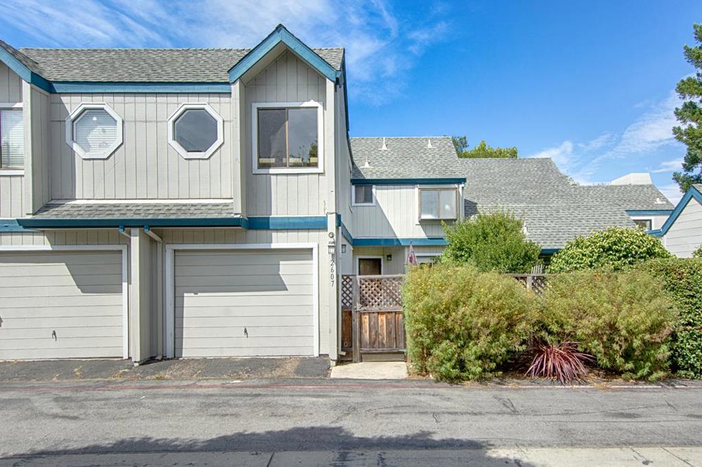 Spacious townhome with a unique floorplan in a sought-after location near shopping, beaches, and easy freeway access. The inviting living room with cozy fireplace opens to a private patio, perfect for outdoor dining or relaxation. A rare and versatile sunroom offers endless possibilitiesideal for a reading nook, art studio, or indoor garden. The spacious primary suite features a charming balcony, walk-in closet, and a large, sun-filled bathroom with a luxurious sunken tub. Two additional bedrooms include one perfectly suited as a home office or guest room. An attached garage adds convenience and storage. With its blend of comfort, character, and prime location, this home offers the best of coastal living.