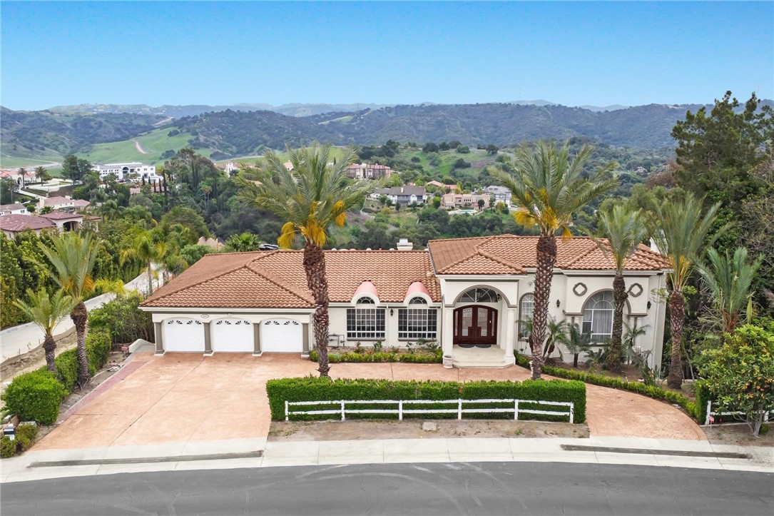 LOCATION! LOCATION! LOCATION! Situated in the secure and prestigious Country Estates, this property offers 24-hour security and patrol services, ensuring unmatched safety and peace of mind. The home features a four-car garage with three doors and a spacious circular driveway, perfect for hosting events and accommodating multiple guests. Each bedroom in this stunning home provides breathtaking mountain views and includes a luxurious suite with a walk-in closet. The main level boasts a soaring ceiling entrance, formal living room, family room,formal dining room, an open kitchen with a prep kitchen, a wet bar, an office, powder room and a secondary master suite. An elevator provides easy access across all floors, ideal for all family members. The second floor hosts three additional bedroom suites, a library, and a family room alongside the primary master suite that offers the pinnacle of comfort. The entertainment-focused ground floor opens up to a vast backyard, ready for the addition of a swimming pool or tennis courts, significantly increasing the property's value. The lot already includes a basketball court with enough space to add a tennis court. The expansive backyard also features an outdoor restroom and bathroom—perfect for a post-swim shower—and is equipped with an outdoor BBQ and extensive leisure areas. Located in the highly acclaimed Walnut Valley School District, with schools achieving scores of 9/9/10, this home is not only a luxurious retreat but also a smart investment for both living and potential future resale.