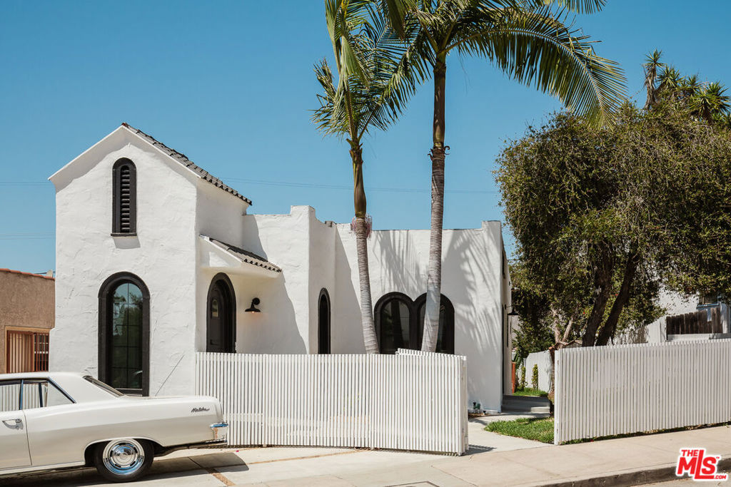 Welcome to 2353 Lucerne Ave, where timeless elegance meets modern luxury in this stunning Spanish Revival home that will capture your heart from the moment you arrive behind the charming white picket fence and discover your personal sanctuary a gorgeous retreat adorned with swaying palm trees, vibrant birds of paradise, and mature landscaping that creates an instant sense of tranquility. Enter through the welcoming foyer where beautiful marble tile floors gleam beneath soaring ceilings and an elegant chandelier sets the tone for the sophistication that flows throughout, as European oak floors guide you through graceful arched entryways into the completely renovated kitchen where your culinary dreams come alive with brand-new stainless steel appliances, a professional gas cooktop, and stunning tile work extending to the ceiling, all crowned by a custom-made range hood that serves as both functional art and conversation starter. The sun-drenched dining room showcases the home's original character with beautiful arched windows flooding the space with natural light while French doors open to the private side yard, creating seamless flow between kitchen, dining, and living areas that makes hosting a joy. Down the thoughtfully lit hallway, you'll discover a versatile first bedroom perfect as a guest suite or home office, plus a bathroom that's a work of art itself with unique tile floors and perfectly placed sconces creating spa-like ambiance, while convenient laundry placement keeps daily life effortless. The true showstopper awaits in the primary suite your personal oasis featuring peek-a-boo views, a palm tree framed perfectly outside your window, a generous walk-in closet, and the crown jewel master bathroom where luxury knows no bounds as you imagine starting each day with breathtaking views of the Santa Monica Mountains and Culver City from your soaking tub or refreshing in the double shower with double vanity convenience. Step outside to the back deck that beckons for morning coffee or evening gatherings surrounded by fruit trees that add both beauty and bounty to your daily life, while the detached garage offers endless possibilities as an art studio, motorcycle haven, or extra storage, complemented by easily accessible under-house storage and a newly redone front parking spot that seamlessly blends 1920s character with today's lifestyle needs. This isn't just a house it's your gateway to the California dream, where every detail has been carefully curated to create a living experience that's both luxurious and livable, so don't just imagine your perfect home come see it at 2353 Lucerne Ave and make this Spanish Revival masterpiece your own.