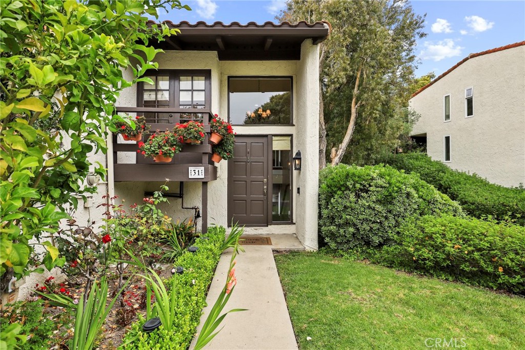 Gorgeous, Private End Unit – Largest Floorplan in The Terraces! Welcome to this beautifully updated end-unit townhome, featuring the largest floorplan in The Terraces and exceptional privacy. Nestled against a lush greenbelt with direct access to peaceful walking paths, this home feels like your own private retreat. Enjoy the oversized wraparound deck overlooking a serene, park-like setting – perfect for morning coffee, outdoor dining, or simply relaxing in your sanctuary. Inside, natural light floods the home, highlighting stunning hardwood floors, vaulted ceilings, and a grand fireplace in the spacious living room. The fully remodeled kitchen (2023) boasts white custom cabinetry, quartz countertops, top-of-the-line appliances, and a sunlit breakfast nook. A formal dining area offers the perfect space for hosting family and friends. On the main level, you'll also find a versatile den or office with French doors leading to a quaint balcony. Just down the hall, a bedroom and updated full bath with a walk-in shower offer flexible options for guests or multigenerational living. Downstairs, the expansive primary suite includes two large walk-in closets, a dressing area, sitting space, and an en-suite bath with double sinks. Sliding glass doors open directly to the greenbelt, extending your living space into the tranquil outdoors. A second bedroom on the lower level also features greenbelt access, mirrored closets, and a remodeled bathroom in the hall. Additional highlights include: a roof replacement (2018), full home re-pipe (2016), new garage door and EV charger (2018), two-car garage with built-in shelving and generous storage space, and a dedicated laundry room with built-in cabinets for even more storage. Prime location within the community – quiet and private with ample guest parking just out front. This home blends comfort, elegance, and function in one of the most desirable settings in The Terraces, a gated community with a 24-hour guard, five swimming pools, tennis court, playground, and clubhouse.
Come experience it for yourself!