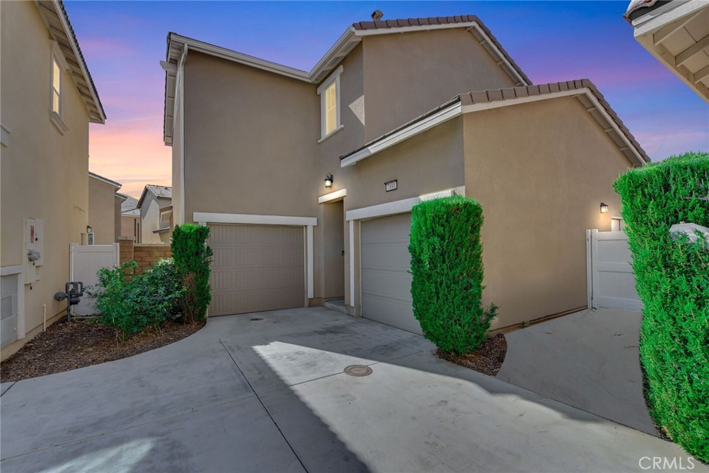 WELCOME HOME! This beautifully upgraded, newly built, move-in-ready residence is tucked inside the highly sought-after gated community of Bayberry at Spring Mountain Ranch! Offering 4 spacious bedrooms and 3 full bathrooms, this detached home blends modern comfort with timeless style. Step inside to discover a bright, open-concept floor plan with upgraded laminate flooring throughout. Your main-floor bedroom and full bath provide the perfect setup for guests or multi-generational living. At the heart of the home, the chef’s kitchen; impresses with crisp white cabinetry, elegant granite countertops, and stainless-steel appliances and it flows seamlessly into the dining and living areas—ideal for entertaining and everyday living alike. Upstairs, your primary suite boasts stunning views of the surrounding hills, a luxurious spa-inspired bathroom with dual sinks, a soaking tub, a separate shower, and a generous walk-in closet. Two additional bedrooms also have stunning views of the surrounding hills and share a thoughtfully designed Jack-and-Jill bathroom, providing both privacy and convenience. Outside, enjoy a low-maintenance, drought-tolerant yard with no rear neighbors—just private and tranquil hillside views. Additional highlights include two separate automatic garages, both offering direct interior access. Located in a newer master-planned community, this pristine home delivers modern living, peace of mind, and incredible value. This house is just minutes from to UC Riverside, Cal Baptist University, Loma Linda Hospital and Loma Linda University and Metro link. Truly turnkey and ready for you to move right in!