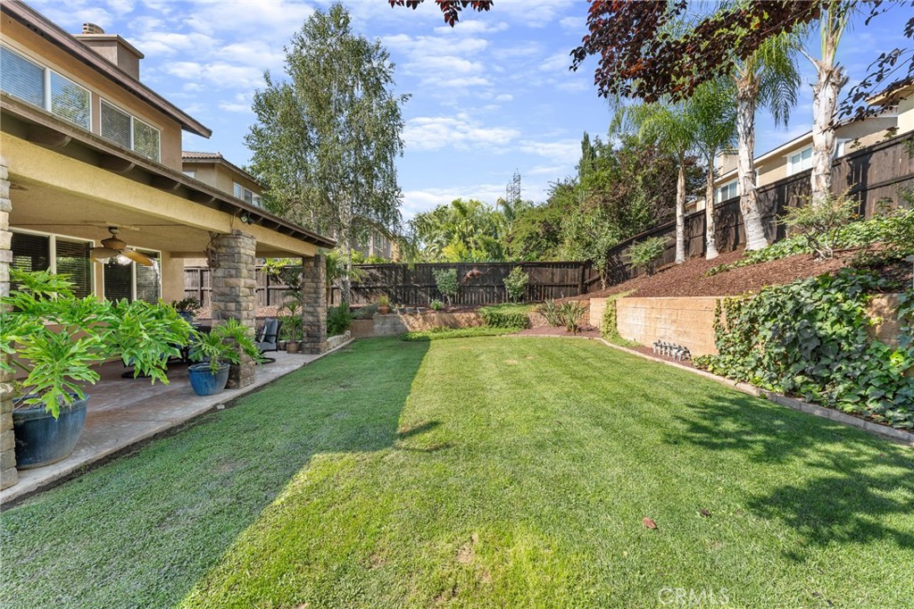 Step into this stunning 4-bedroom, 2.5-bath home in desirable Fairway Canyon 2,762 sqft of thoughtfully designed living space, attached 3-car tandem garage, perfect for entertaining and everyday life. Formal living and dining rooms provide elegant gathering spaces (the dining room opens to a quiet courtyard), while the open family room and kitchen create the heart of the home with a large island, walk-in pantry and plentiful counter space. Glass doors flow to a beautifully landscaped backyard with a large covered patio and completely flat, usable lawn — ideal for BBQs, cocktails and safe play for kids and pets. The upstairs primary suite is a retreat made for a king and queen offering dual vanities, a soaking tub, separate shower and generous walk-in closets. Practical upgrades include a newly installed roof on back patio, water heater, dishwasher and air conditioner. HOA amenities — pool, spa, golf course, park and playground — this is a rare Fairway Canyon find.