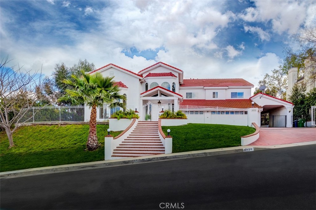 The Hills of Tarzana ENJOY views that go as far as the eye can see! Located on a very private cul-de-sac this custom-built gated home is an entertainer's dream. The estate features an impressive grand entrance hall with an elegant spiral staircase, open plan formal living room and dining room with Columns and 25 foot ceilings. Kitchen has been Remodeled with stove, countertops and farm-style sink. The family room has a built in with wet bar next to the dual glass sliding doors to the backyard. Luxury home sits on a huge lot of land featuring pool with spa, a koi pond with built in waterfall and lush citrus and fruit trees oasis. Primary bedroom has views of the city/ golf course and a balcony to enjoy indoor-outdoor living, has a his and her full bathrooms and his and her closets that are separate rooms within the primary bedroom suite. Two more bedrooms upstairs each with full bathrooms and in the hallway is a laundry chute to laundry room on first floor. Two bedrooms located downstairs and one full bathroom. Attention to detail is what this home offers and covered RV, boat parking on the side of the home not to mention a finished 3 car garage.