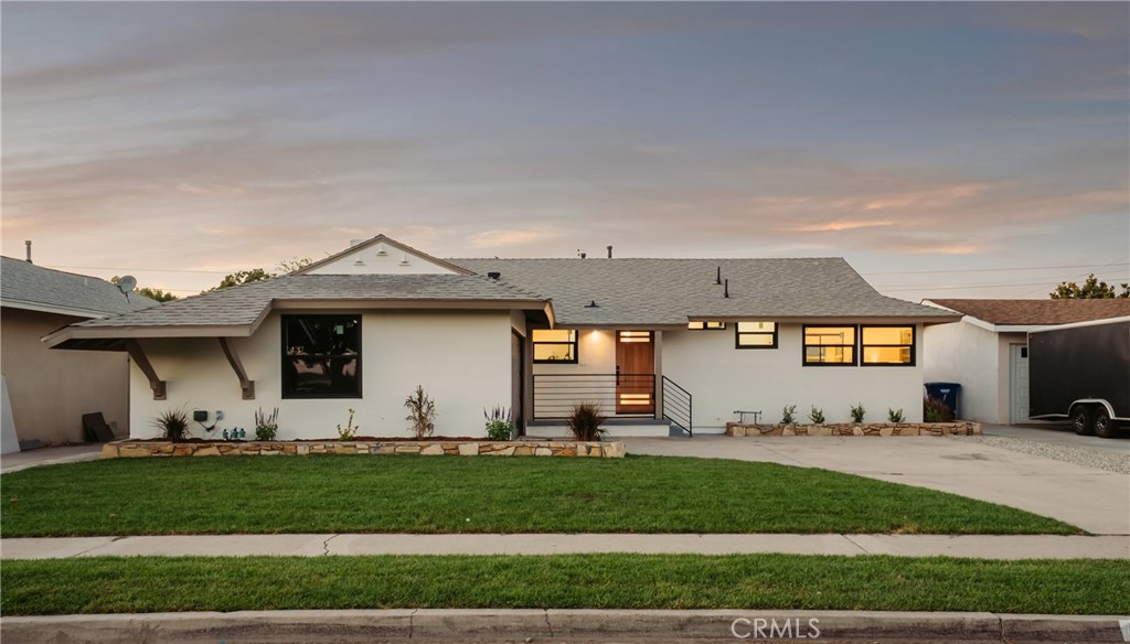 Welcome to your beautifully reimagined California dream home, where modern comfort, and an unbeatable location come together to create the perfect start to your next chapter. Step inside to discover a bright, open-concept layout. Equipped with a stunning white oak kitchen, a six-foot quartz island, and designer finishes throughout. New retrofit windows and oversized french doors imbue the space with natural light, while updated bathrooms, modern lighting, and luxury vinyl flooring create a fresh, cohesive look. Every detail of this home has been elevated, from the chic designer tilework, dry bar, garage door, and outdoor patio. Additional upgrades include a new electrical panel and a new HVAC system for the next homeowner to enjoy. Located just 5 minutes from Knott’s Berry Farm and a quick drive to Disneyland, this is the perfect starter home, Air BNB rental or investment property.