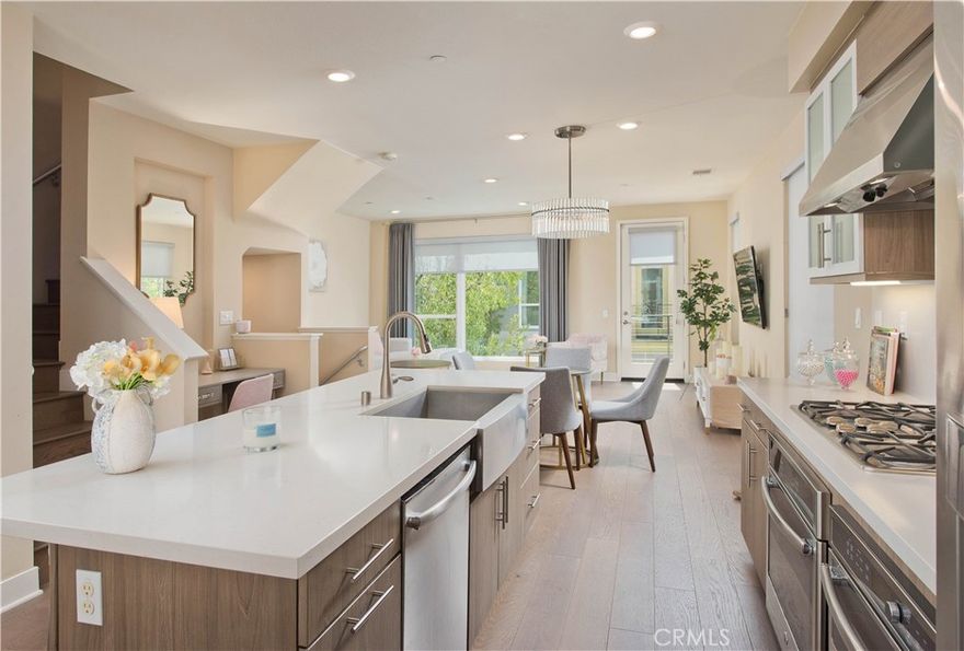 Welcome to this stunning contemporary residence with no detail overlooked! Offering sophisticated designer touches, open-concept living spaces, abundant natural light, and perfectly positioned within a gated community offering serene Hollywood hillside views. The magnificent gourmet kitchen is the central showpiece, complete with a grand breakfast bar island, sleek cabinetry, premium stainless-steel appliances, and open dining space—perfect for both everyday living and your holiday gatherings. Opening from the kitchen is the wonderful great room styled living room with sunlit picture windows and plenty of space to entertain with comfort! Encompassing three spacious bedrooms, that include the expansive primary suite showcases serene hillside views, a spa-inspired bath with dual sink vanity, oversized shower, dressing area and generous walk-in closet. A second upstairs suite offers its own private bath and walk-in, while a private guest suite on the lower level provides comfort and flexibility for visitors, work-from-home needs or your private gym. Step outside to a secluded backyard oasis featuring a wonderful patio lounge, built-in BBQ with bar, and ample space for relaxing under the stars. Additional highlights include a two-car garage and a secure gated community setting. Ideally located moments from Hollywood’s iconic attractions, dining, and nightlife. Blending luxury, privacy, and urban convenience—your contemporary Hollywood retreat awaits.