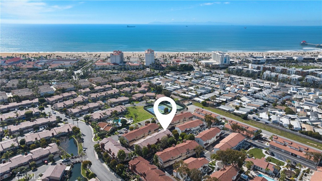 Indulge in the quintessential beach lifestyle just steps away from the renowned Surf City USA shores. Nestled within the vibrant coastal community of Seaside Village, this turnkey haven epitomizes the essence of active living. Whether you're a devoted surfer catching the morning waves, love beach boardwalk strolls or a beach enthusiast soaking up the sun, this location caters to your seaside desires. Immerse yourself in the local beach vibe, where coastal events beckon and charming boutiques and eateries await at nearby Pacific City. Beyond the sandy shores, embrace a plethora of recreational amenities right at your doorstep. From refreshing dips in the pool and spa to friendly matches on the tennis and sport courts, every day offers a new adventure amidst the backdrop of this dynamic neighborhood. Step inside this meticulously upgraded residence to discover a sanctuary of modern comfort and style. Luxurious vinyl flooring sets the stage in the inviting lower-level family room, accented by a cozy fireplace and seamless access to the private patio retreat or to the direct access 2-car garage. Ascend to the main level, where an expansive open floor plan awaits, seamlessly connecting the formal dining room with gorgeous chandelier to this gourmet kitchen, and versatile living space, ideal for entertaining or crafting a home office sanctuary. The kitchen dazzles with custom upgrades, boasting sleek Shaker cabinetry, a sprawling sit up island with pendant lighting, and premium appliances, including an under-counter microwave and mini wine fridge. Upstairs, retreat to the generously proportioned primary suite, featuring a spacious layout, Cal-King bed accommodations and more, and a lavish ensuite bathroom adorned with elegant herringbone tile and contemporary fixtures. Two additional bedrooms offer ample space both with dual closets, perfect for guests or crafting a personal sanctuary. These rooms share a remodeled hallway bath with shower over tub adorned with detailed subway tile enclosure. Throughout the home, thoughtful details abound, from dual-pane windows and sliders, recessed lighting to updated switches and outlets, ensuring both style and functionality. With its prime location, amazing ocean breezes, upgraded features, and vibrant coastal lifestyle, this residence presents an unparalleled opportunity to live the beach life you've always dreamed of. Welcome home to coastal bliss.
