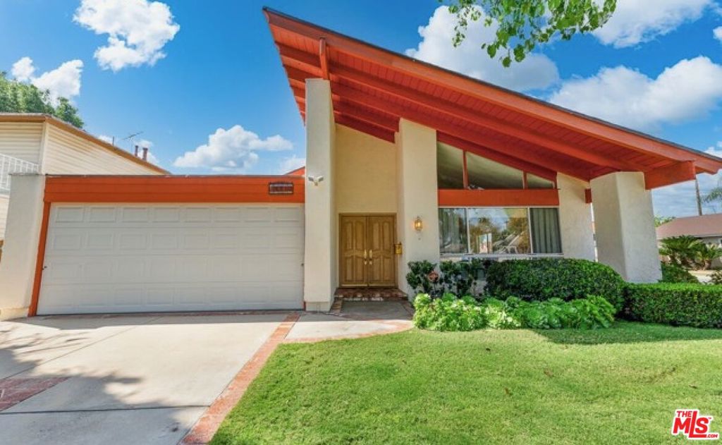 This beautiful corner-lot property is located on a cul-de-sac in a quiet, tree-lined neighborhood with no through traffic. Designed by renowned architect Barry Alan Berkus, the home boasts 4-bedrooms and 2.5-bathrooms with a stunning mid-century aesthetic. The sunken, light-filled formal living room with fireplace, new bamboo flooring, and a 16-foot vaulted ceiling welcomes you from the double-door entrance. A powder room is nestled next to the formal living room and bright formal dining room. The large open kitchen is steps away from a second living room and yard, which offers a covered patio and lawn. A wet bar with passthrough access to the patio adds to the open floor plan and entertaining opportunities. An ensuite bathroom with a jacuzzi tub is located in the spacious and private primary bedroom, and all three additional bedrooms are large with ample storage space. Recent upgrades including a new roof, HVAC, garage door, side fence, sprinkler system reflect the owner's care and attention to detail. Located just minutes from the LA Rams' new $10B investment in Warner Center Woodland Hills, and with the North San Fernando Valley Metro improvements underway, this location is positioned to benefit from the area's next chapter of growth. If you have any further interest in this property, please EMAIL the listing agents directly.
