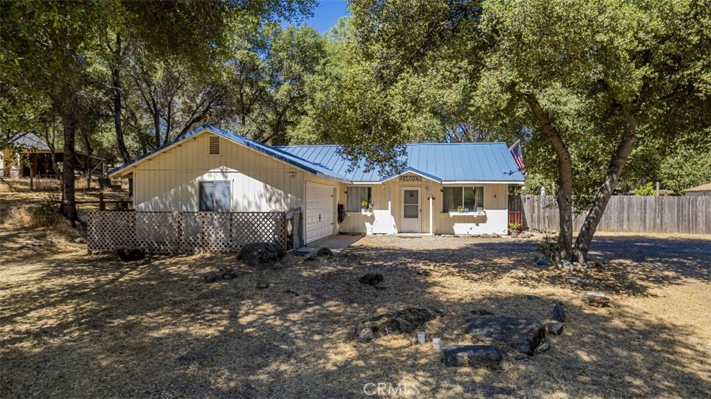 Be sure to check out this great find in the Indian Lakes community which offers 4 bedrooms for that extended family. One of the bedrooms is located within the garage area and having it's own mini split system for heat and air conditioning. The home has been updated with mini split systems throughout, a pellet stove to keep you cozy in those cooler months as well and all this with helping to keep your energy costs down. Having a newer metal roof adds to the low maintenance and with granite counters in the kitchen as well along with being freshly painted inside. Ready for a generator with the connection all set. Nice usable 1+/- acre while maintaining privacy on the wooded lot and an easy commute to either Oakhurst or Fresno. Indian Lakes offers a small community park with a covered barbecue pavilion, fenced-in play area for children, bathrooms and a pond to enjoy a stroll around or catch and release fishing.