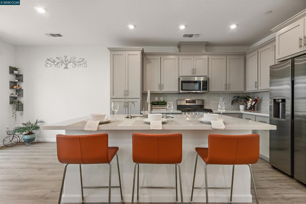 Located in the highly desirable San Marco community of Pittsburg, this stylish, energy-efficient duet built in 2021 offers 3 bedrooms, 2.5 bathrooms, and an attached 2-car garage. Step inside to find an open-concept layout with high ceilings, abundant natural light, and contemporary finishes throughout. The gourmet kitchen features quartz countertops, stainless steel appliances, ample cabinetry, and a spacious island—ideal for cooking and entertaining. The bright living and dining areas flow seamlessly to a cozy private patio. Upstairs, the spacious primary suite includes a spacious walk-in closet and an en-suite bathroom with dual vanities. Energy-efficient features include owned solar panels, a tankless water heater, and dual-pane windows, helping you save on utility bills year-round. HOA amenities include basketball, bocce and picnic area. Just a 1–2 minute drive to Starbucks, Sprouts Grocery, Cold Stone Creamery, and more. Just minutes from Pittsburg Center BART, this home offers an easy 15-minute ride to Concord, about 35 minutes to Oakland, and under an hour to downtown San Francisco—ideal for professionals working at Kaiser, John Muir Health, PG&E, or in the Financial District. A dream location for East Bay and city commuters alike.