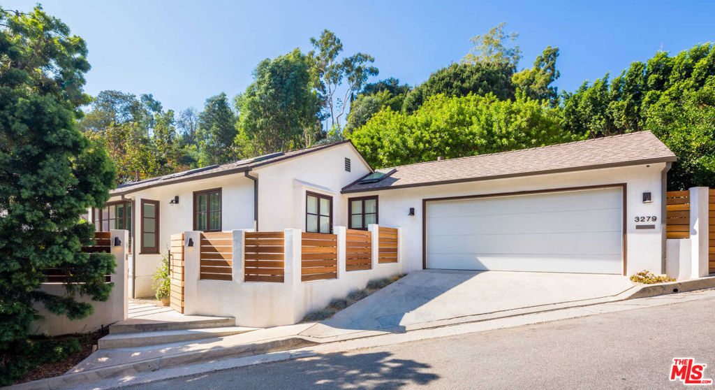 This beautiful Hollywood Hills hideaway is the perfect blend of modern design and understated elegance. Gated and private, this three-bedroom home was re-imagined by the iconic Nicole Sassaman and features open-space design with abundant natural light, bespoke custom cabinetry, gourmet kitchen, en-suite bedrooms, and a beautiful private garden with outdoor barbecue, dining, and fire pit. As smart as it is stylish, this home features cutting-edge technology including Control 4, drop-down hidden projector, built-in sound system, Velux Solar sky lights, and fully integrated Miele appliances. Located on one of the most coveted streets up Beachwood Canyon, this intimate and chic home offers an extraordinary living experience just moments from the heart of Hollywood.