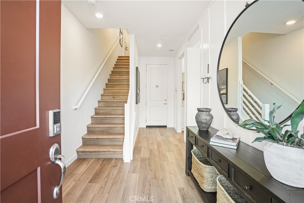 Welcome to 27306 Bear Creek Lane—Plan?1987—an elegant three-story townhome in KB?Home’s Iris at Valencia community, with approximately 1,987?sq?ft, 3 bedrooms, 3.5 baths, and an attached two-car garage. Thoughtfully designed with open living areas and 9-ft ceilings, the home features luxury vinyl plank flooring throughout, a gourmet kitchen with Blanco Maple Silestone countertops, island with USB charging port, Samsung stainless steel appliances including a smart induction range, and shaker-style white cabinets with chrome accents. The expansive primary suite includes a clear glass shower, dual under-mount sinks with chrome Moen fixtures, and generous walk-in closet. Secondary bedrooms have mirrored wardrobe doors; all baths have Silestone counters and energy-efficient Kohler fixtures. Additional upgrades include a prewired EV charging station, designer lighting, brushed nickel pendants, and a leased 8-panel Sunrun solar system. Plan?1987 is an ENERGY?STAR® certified home built for modern, healthy living. Situated within Valencia’s premier master-planned community, residents of Iris enjoy large private front patios, resort-style amenities—including swimming pools with cabanas and lounges, recreation center, garden, and an adventure playground—over 30?miles of interconnected trails for walking, biking, or NEV use, scenic mountain views, and proximity to award-winning Saugus Union and William S.?Hart schools. Convenient to I-5, Hwy?126, local universities and hospitals, and retail/dining/entertainment at Westfield Valencia Town Center, The Patios, and Six Flags Magic Mountain—this home combines thoughtful design, sustainability, and a vibrant lifestyle.