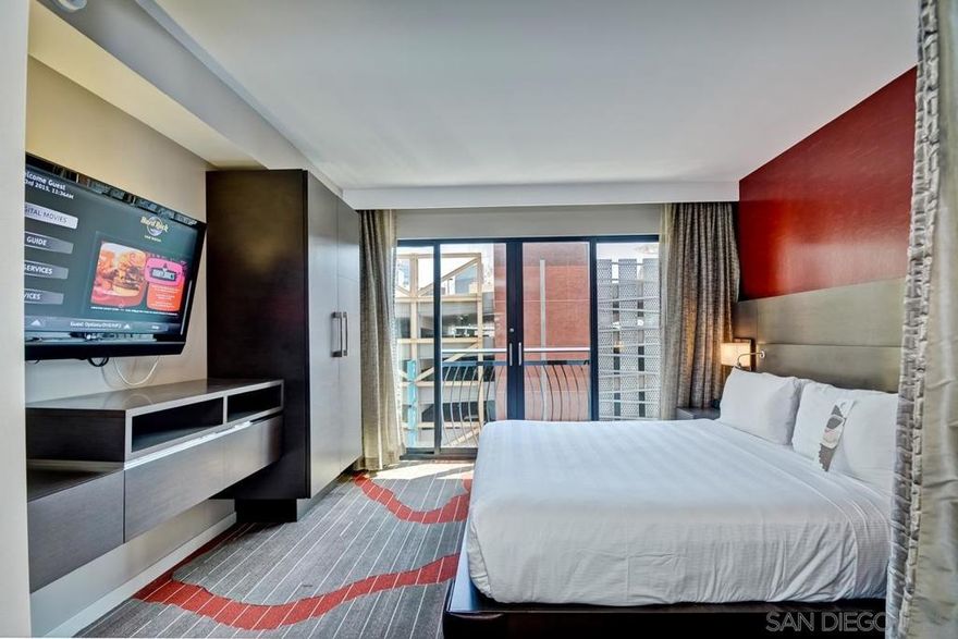 CASH ONLY — Located in the heart of the Gaslamp Quarter, directly across from the San Diego Convention Center, the Hard Rock Hotel offers unmatched access to Downtown’s most iconic attractions. Residence 442 is an east-facing one-bedroom suite featuring a king bed, separate living area, and a semi-private sleeping space divided by a privacy curtain.   This fully furnished unit is part of the hotel’s exclusive Rock Royalty program and offers owners access to luxury amenities and concierge-level service, including a private owner’s lounge. Owners may place their unit in the hotel’s rental management program, allowing flexible personal use (28 days a year for free with an option to stay longer at a discounted rate) while generating potential revenue. Unlike traditional condos, these units are not for full-time occupancy (there is no kitchen ) and cannot be used as a primary residence.
