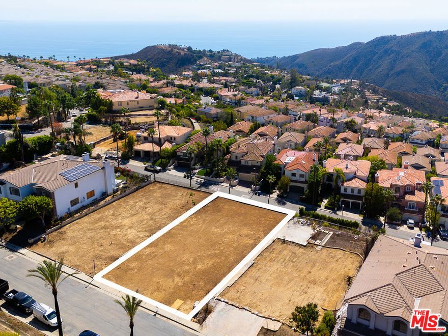 Perched high in Pacific Palisades' Summit Enclave, this panoramic ocean and mountain view lot within this highly coveted, guard-gated community offers a rare opportunity to own, design, and build a custom estate that captures the essence of the Southern California lifestyle. From its elevated vantage point, the property showcases sweeping, unobstructed views of the Pacific Ocean and surrounding mountains, creating an inspiring backdrop for a new architectural vision. The oversized lot, formerly home to a 5,700-square-foot residence with pool/spa, is now fully cleared and ready for immediate development, with both the EPA Phase I environmental assessment and Phase II debris removal complete. Residents of "The Summit" enjoy an exclusive resort-style lifestyle with exceptional amenities including tennis courts, an Olympic-sized swimming pool, spa, fitness center, playground, with basketball and pickleball courts, all just moments from the Palisades Village.