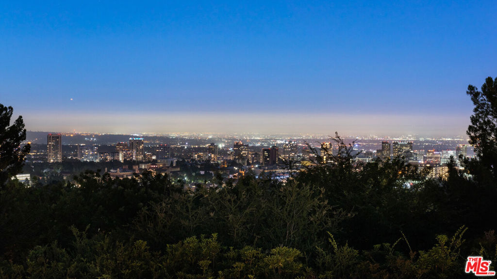 Tucked behind gates within the comfort of Bel-Air among flourishing greenery, this hidden gem is the perfect opportunity for investors and developers to build or remodel an existing estate in a paramount location! Picturesque views await from every vantage point on this promontory displaying the lush environment by day and mesmerizing skyline by night. While conveniently located a stone's throw from the UCLA campus, the Bel-Air Country Club, and just minutes from Sunset Boulevard the property remains rich in privacy and tranquility.