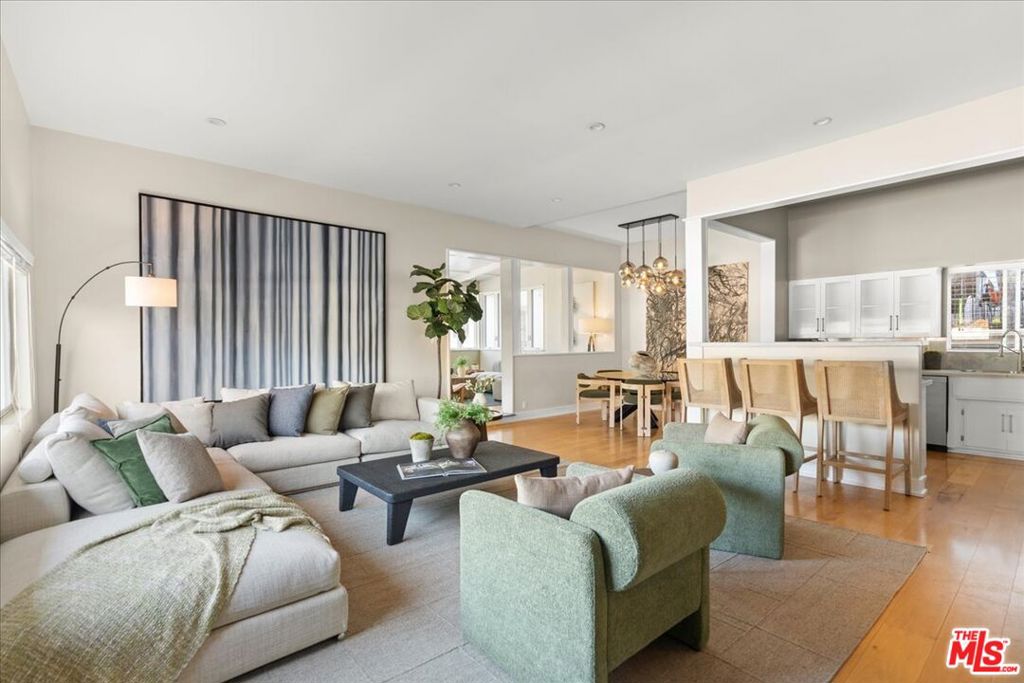 Discover this expansive two-bedroom, two-bath condominium that offers the feel of a single-level townhouse, thanks to its rare and extraordinary large deck and outdoor space that is entirely exclusive to this unit. This deck is one of the largest private outdoor areas in all of Brentwood, providing a serene, tree-lined view that creates a tranquil escape from city life. Imagine entertaining guests or enjoying a quiet evening in your own spacious outdoor living area, perfect for BBQs, lounging, or dining al fresco. Inside, the unit has been completely updated and renovated with meticulous attention to detail, blending modern luxury with functional design. The open floor plan offers a seamless flow between the living, dining, and kitchen areas, making it perfect for both everyday living and entertaining. High ceilings and abundant natural light enhance the spaciousness, creating a bright and welcoming environment. This unit also boasts the coveted Brentwood lifestyle - everything you could desire is just a quick stroll away. Enjoy the convenience of being walking distance to Whole Foods, Katsuya, and Brentwood Village, where you can find SoulCycle, Orange Theory, and some of the best restaurants and boutiques the area has to offer. Additional features include two tandem parking spots (numbers 15 and 16), providing ample parking space, and in-unit laundry for added convenience. This is a rare opportunity to own a beautifully renovated unit with a unique outdoor space in one of Brentwood's most desirable locations. Don't miss the chance to experience luxury living with the best of Brentwood right at your doorstep!