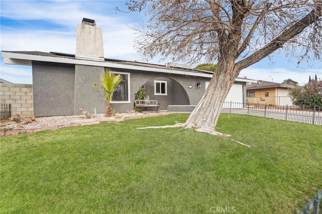 Welcome to this charming 3-bedroom, 2-bathroom home, designed with comfort and privacy in mind. The home features high ceilings, creating an open and airy atmosphere. The thoughtfully designed layout places the PRIMARY BEDROOM ON THE OPPOSSITE SIDE OF HOME, offering a peaceful retreat with its own full en-suite bath for added PRIVACY. The living room is a cozy space, highlighted by a charming FIREPLACE, and includes an enclosed door for the option to create a private retreat or BONUS ROOM. This flexible space can be used as a guest room, home office, or extra living area for extended family. The spacious den adds even more versatility to the home, providing an additional area for relaxation or entertainment. The kitchen is equipped with STAINLESS STEEL APPLIANCES, perfect for any home chef, and the home boasts tiled floors for easy maintenance. Ceiling fans ensure a comfortable environment year-round, keeping rooms cool and breezy. For added convenience, the attached garage provides direct access to the home, making unloading groceries or managing daily tasks a breeze. The SPACIOUS BACKYARD is a true highlight, with a low upkeep paved yard, covered patio, and dog run. ideal for outdoor entertaining or family gatherings. This home offers a perfect combination of privacy, functionality, and style, with the added benefit of SOLAR PANELS for energy savings. REMODELED HALLWAY BATH and NEWER CENTRAL AC and AIR DUCTS for those hot summer days. Don’t miss the chance to make this wonderful property your new home!