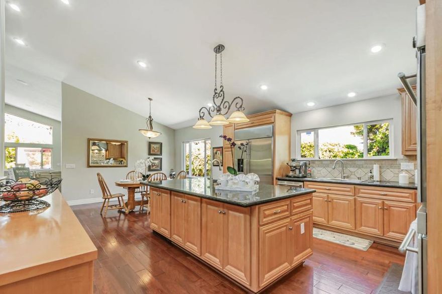 Built with multi-generational living in mind, the home offers an intelligent flow, abundant natural light, & carefully curated spaces for privacy & togetherness. In 2005, this beloved family home underwent a massive renovation designed by a Japanese architect. Spacious, open-concept layout features a large island with a beverage station, dual sinks, dual ovens, a warming drawer, a microwave, & a Thermador professional 48" gas range. GE Monogram appliances, 48" refrigerator, multiple built-in buffets, walk-in pantry offers ample storage, perfect for hosting family gatherings or entertaining guests. Two levels, 9-10' ceilings, high vaulted ceiling in main living area. Private in-law suite with two rooms, ensuite, separate entrance and laundry on main level. Primary bedroom with en suite seating area, dedicated office. Front yard features a beautiful rose garden and a cozy sitting nook, perfect for quiet moments outdoors. Step outside to discover a serene koi pond, surrounded by landscaped backyard creating an inviting & peaceful retreat. Garage converted to recreation room not included in SQFT. Garage door is functional and seller will consider converting back to garage. Solar with 3 Tesla batteries, EV outlet. Home is a MUST SEE to truly experience the space and size.