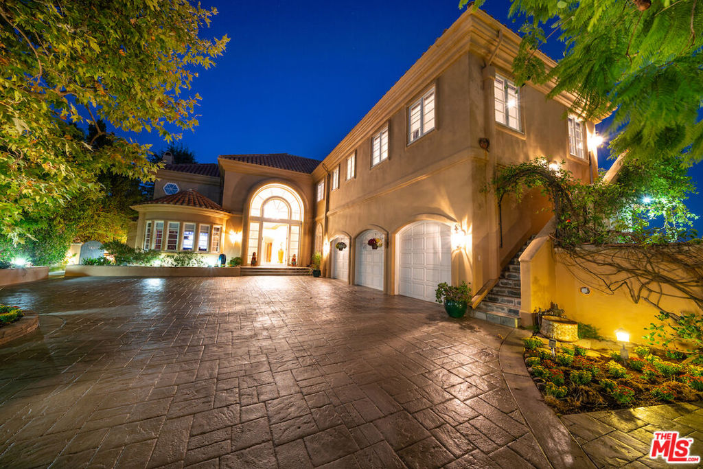 Exceptional Villa in the exclusive and gated Bel Air Crest. This private and secluded Villa sits on a hill at the end of a cul-de-sac, with unobstructed panoramic views. Enter through a chandeliered majestic foyer that sends you into a sumptuous formal living room with space for a piano, complemented with a formal dining room of generous size that calls for great entertaining. This Lower Level also includes a family room with plenty of space and a media room. The majestic staircase at the foyer will bring you to the Upper Level with a 1,200+/-sqft Master Suite with two separate lush bathrooms, two large dressing rooms/walk-in closets, a sitting room, a Swedish sauna, a balcony with magnificent views, and a romantic fireplace. The same Upper Level has three more bedrooms en suite to accommodate everybody. Back in the Lower Level, there is a fifth bedroom en suite for guests or the maid, a 500+ bottles wine cellar that complements a kitchen with everything you dream for: 60 Wolf range, four ovens, commercial Subzero refrigerator, a built-in Miele espresso machine, luxe granite countertops, two dishwashers, 3-motor exhaust hood, and tons of custom cabinetry, making it a dream master chefs kitchen. The large lot surrounds the Villa, creating different garden terraces with lush vegetation and a breathtaking pool to splash in while soaking the spectacular surrounding views. There will never be a shortage of space or panoramic views in this exceptional Villa!