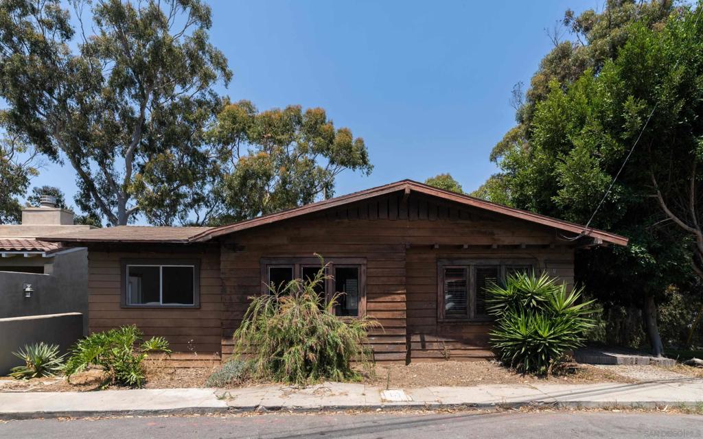 Perched on the canyon rim in a prime location, this bungalow offers a unique opportunity for those seeking to design their dream home in Mission Hills. While not habitable in its current state, this home awaits transformation. Its generous lot with mature trees and sloping terrain offers countless possibilities for a visionary buyer wanting to restore or recreate. Cash offers only.